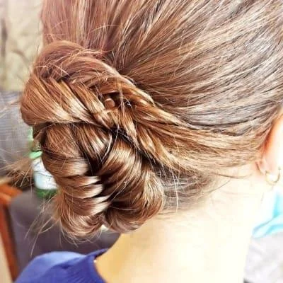 Intricately braided hair bun on a woman's head