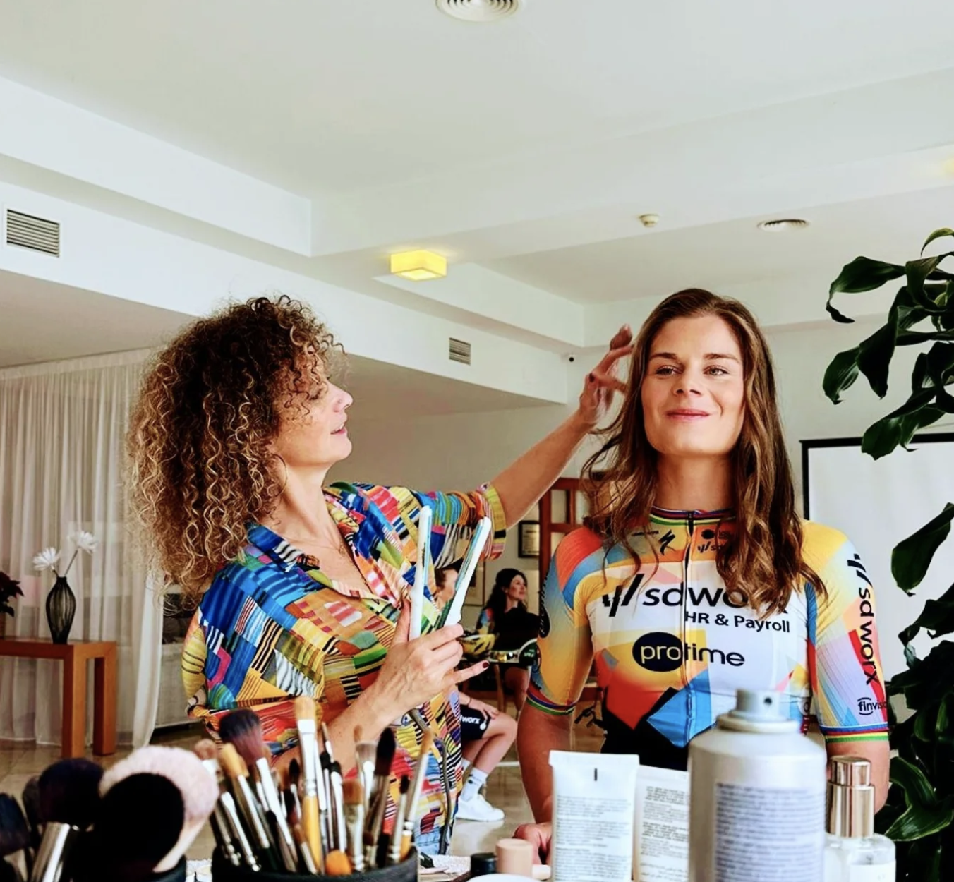 Woman in a black leather jacket posing against a white background