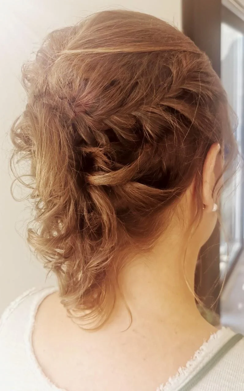 Woman with curly hair in an elegant updo hairstyle