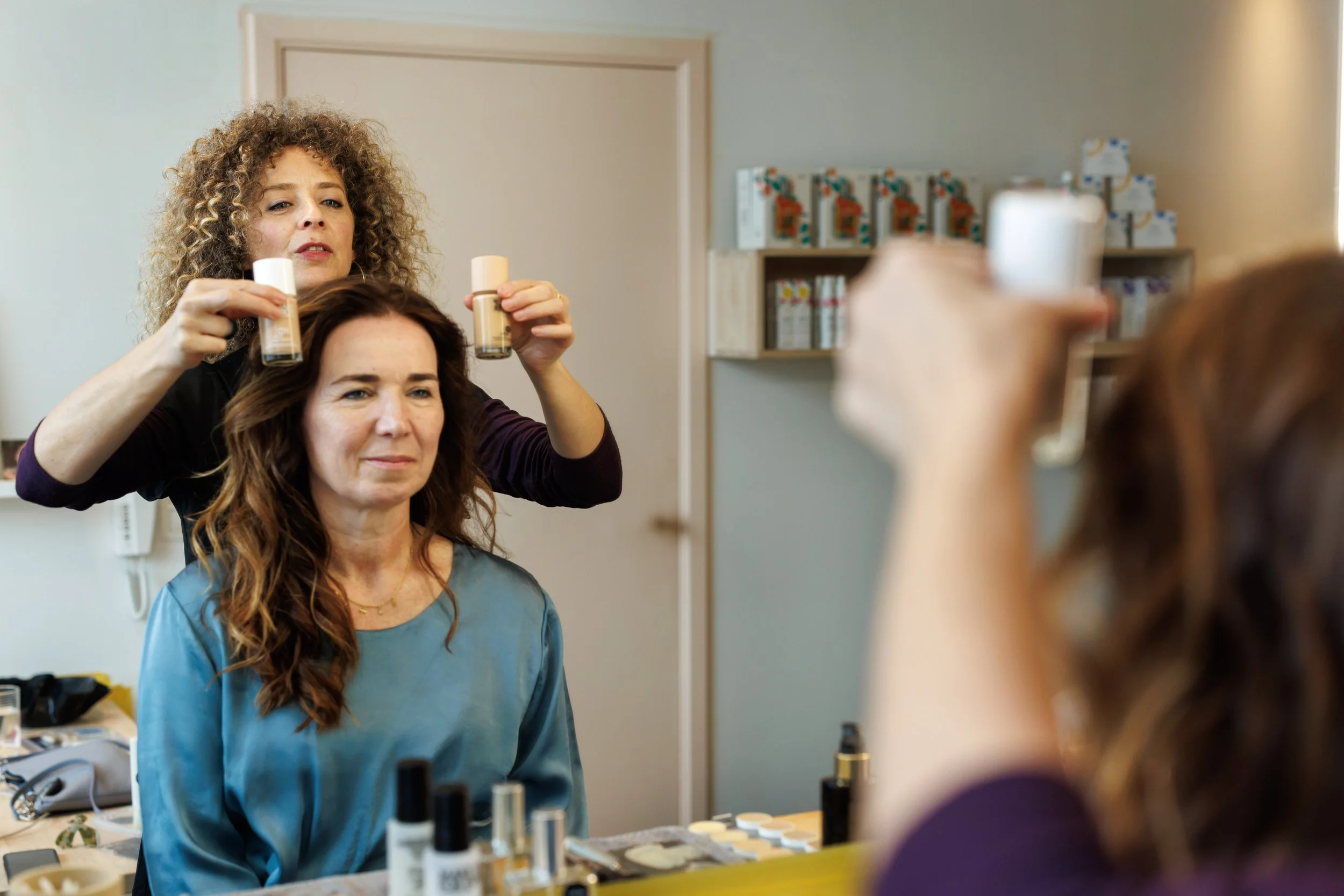 Close-up of a person with braided hair and silver hoop earrings.