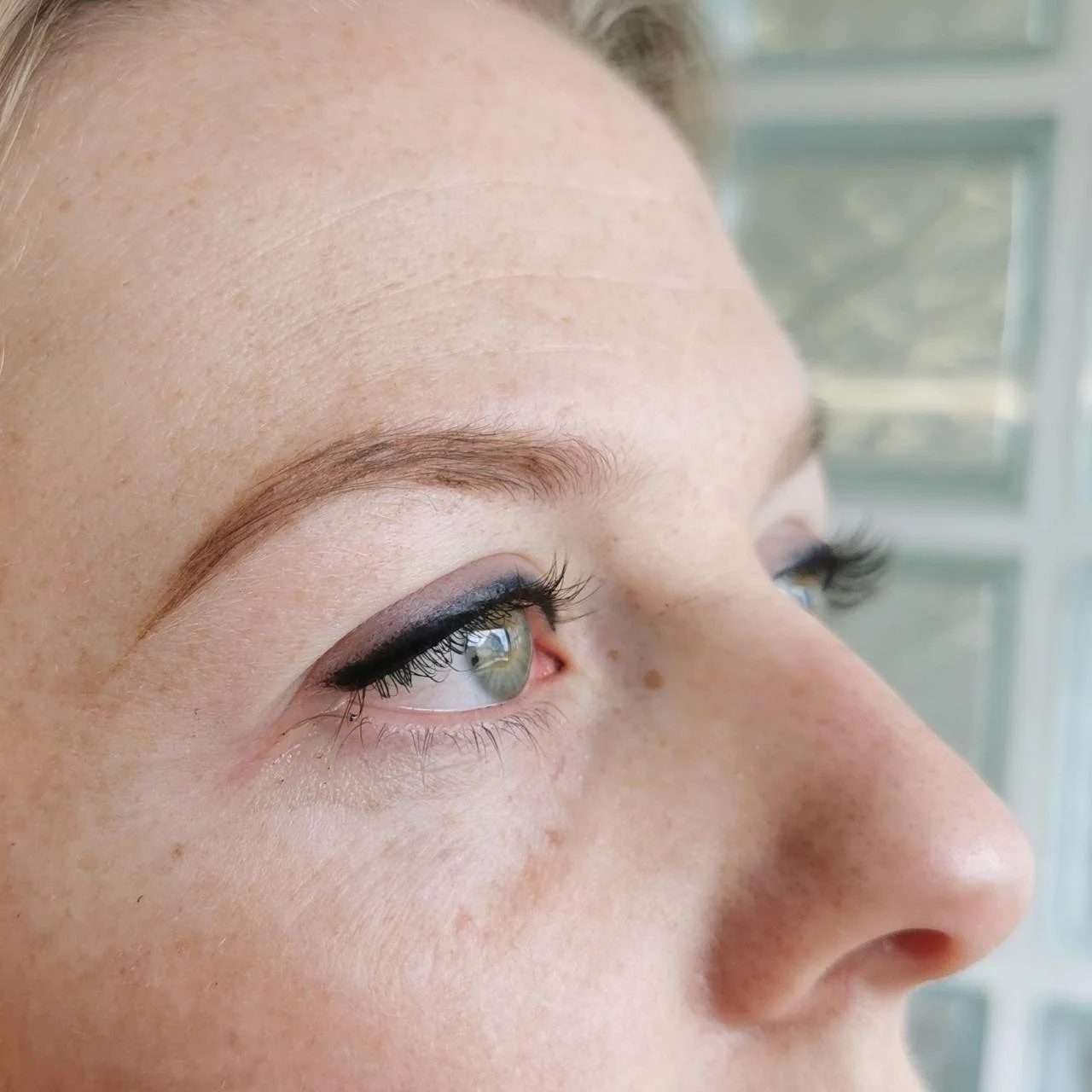 Close-up of a woman's eye with makeup, featuring eyeliner and mascara.