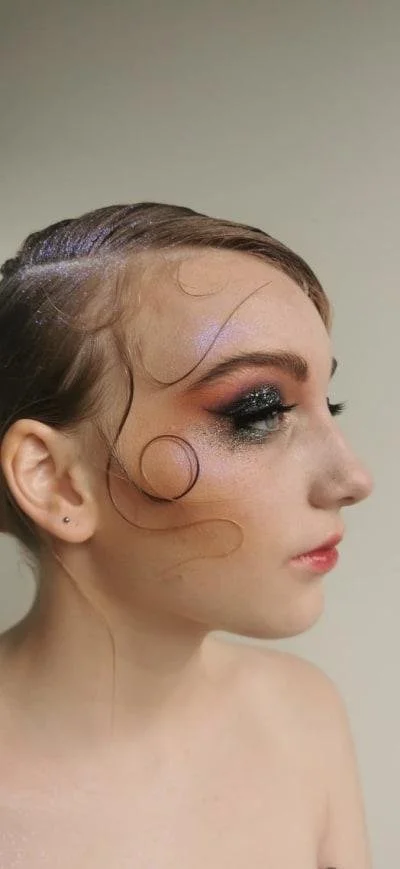 Woman with artistic makeup and styled hair