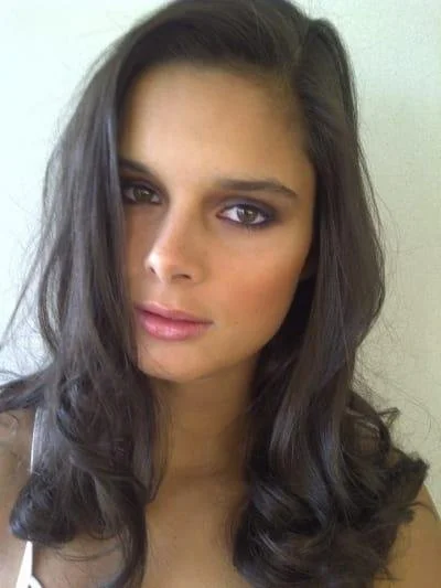Portrait of a woman with long dark hair and natural makeup.