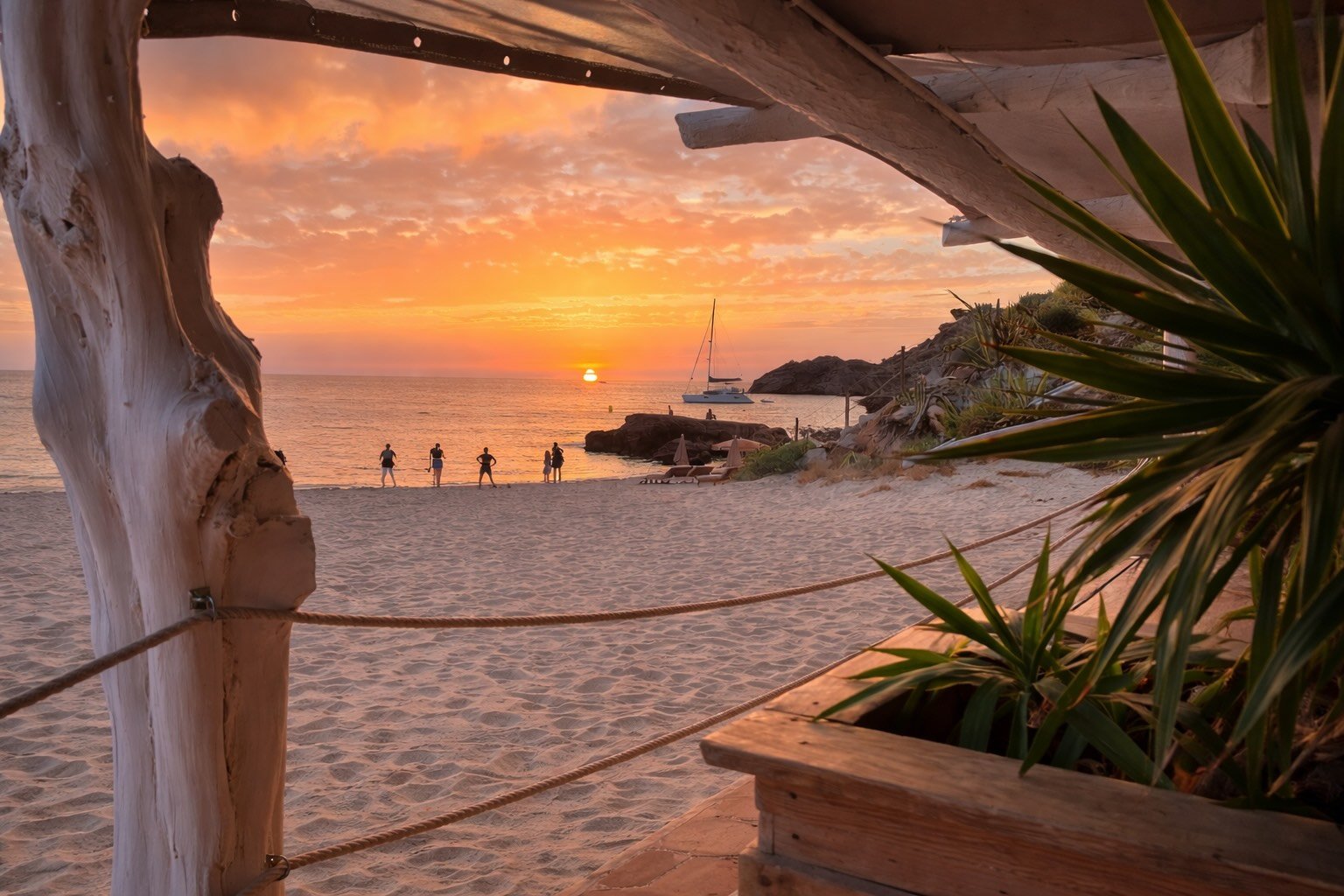Ibiza beach at sunset showing the lifestyle and environment experienced by therapists working abroad in luxury hospitality venues