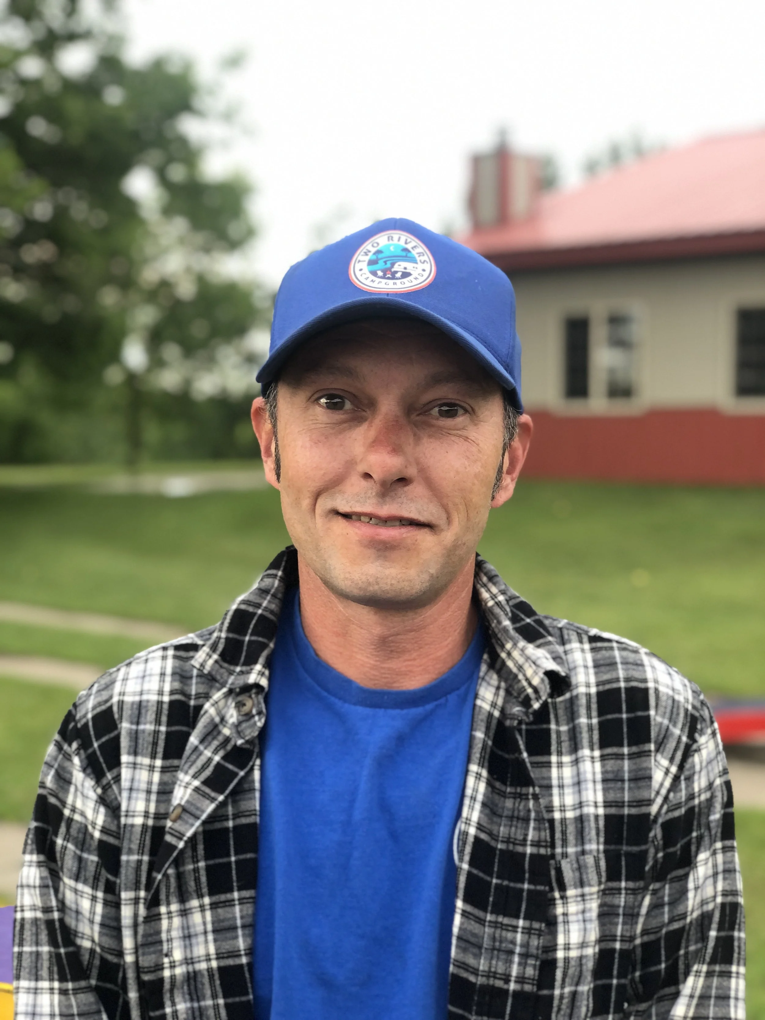Maintenance Manager Aaron Price wearing a black cap and blue hoodie