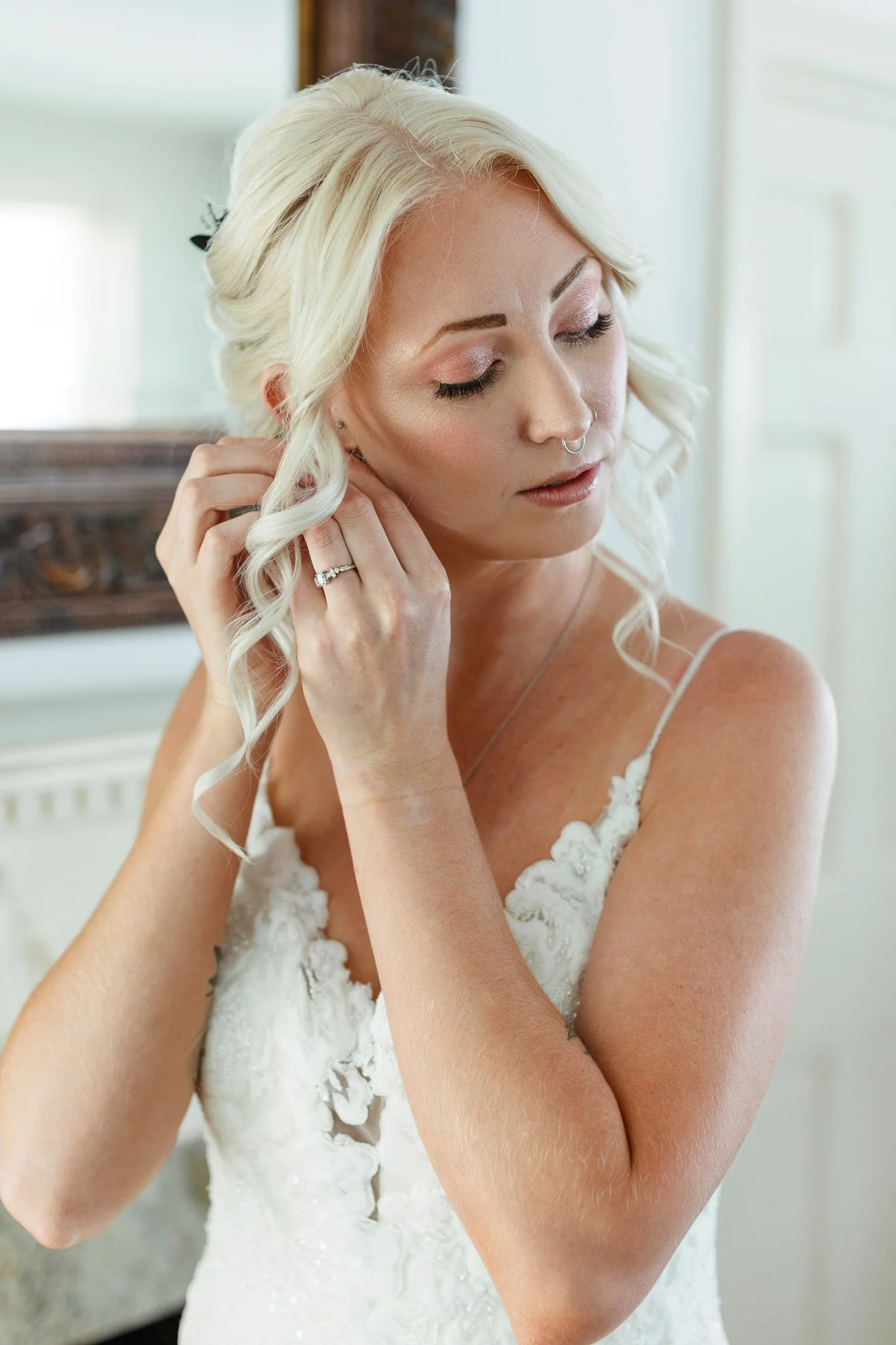 Wedding photography closeup shot of a woman putting her earrings in