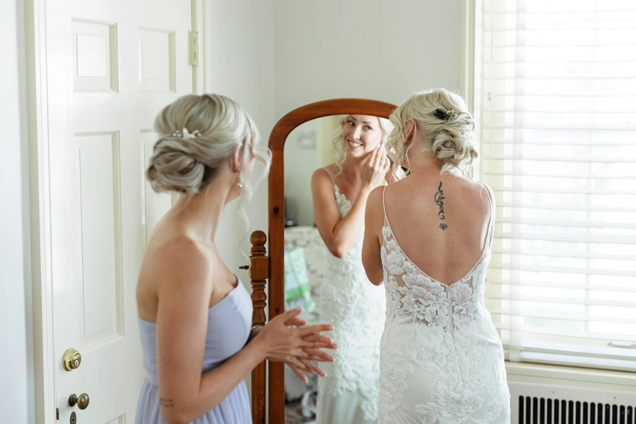 a bride and her bridesmaid get ready inside The Mansion at the Drumore Estate in Pequea, Pennsylvania