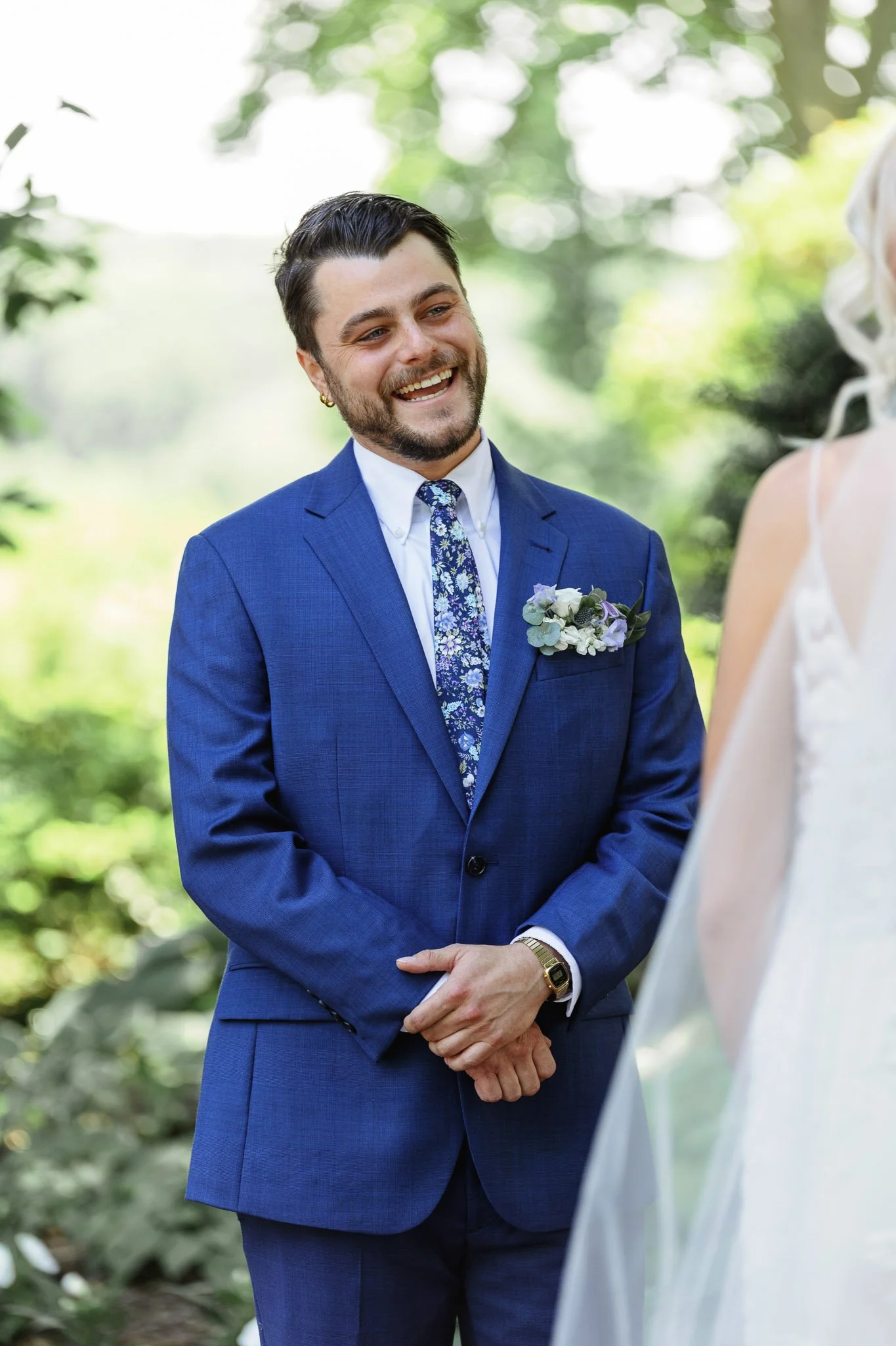 Intimate wedding ceremony at Drumore Estate featuring a bride in a lace gown and a groom in a tailored blue suit.