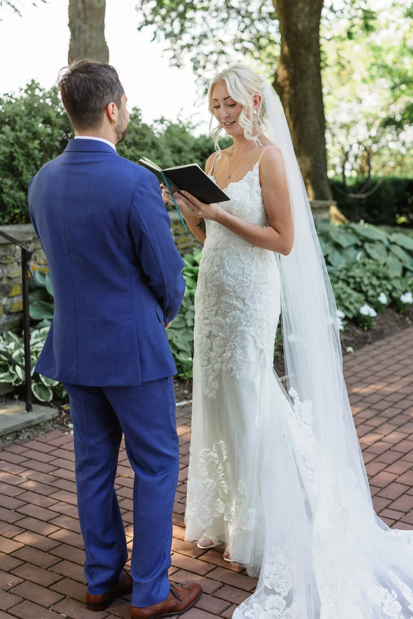 The bride and groom share an intimate moment with their own vows in The Gardens at Drumore Estate