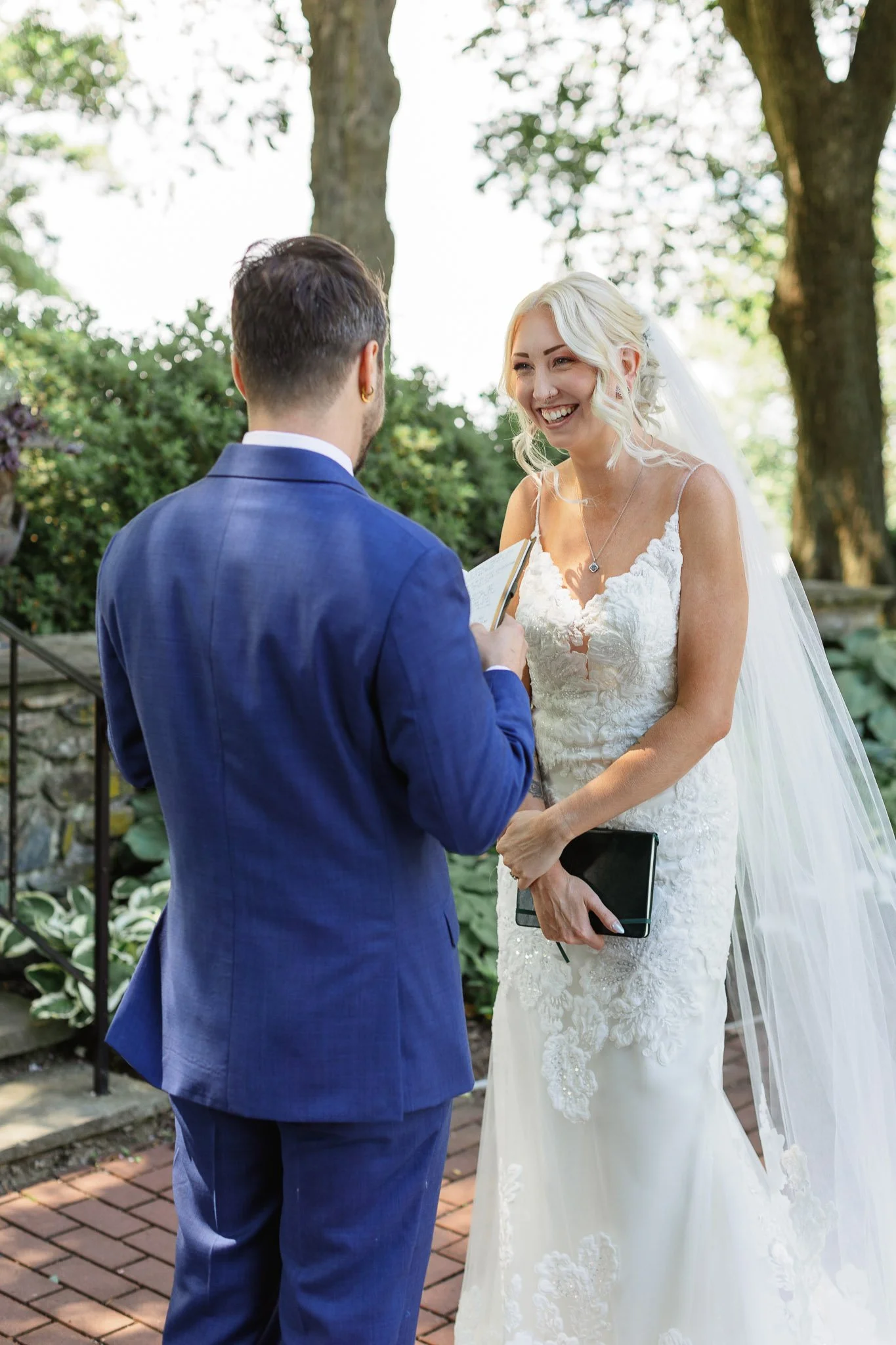 Candid shot by a Pennsylvania wedding photographer of a couple in The Gardens at Drumore Estate.