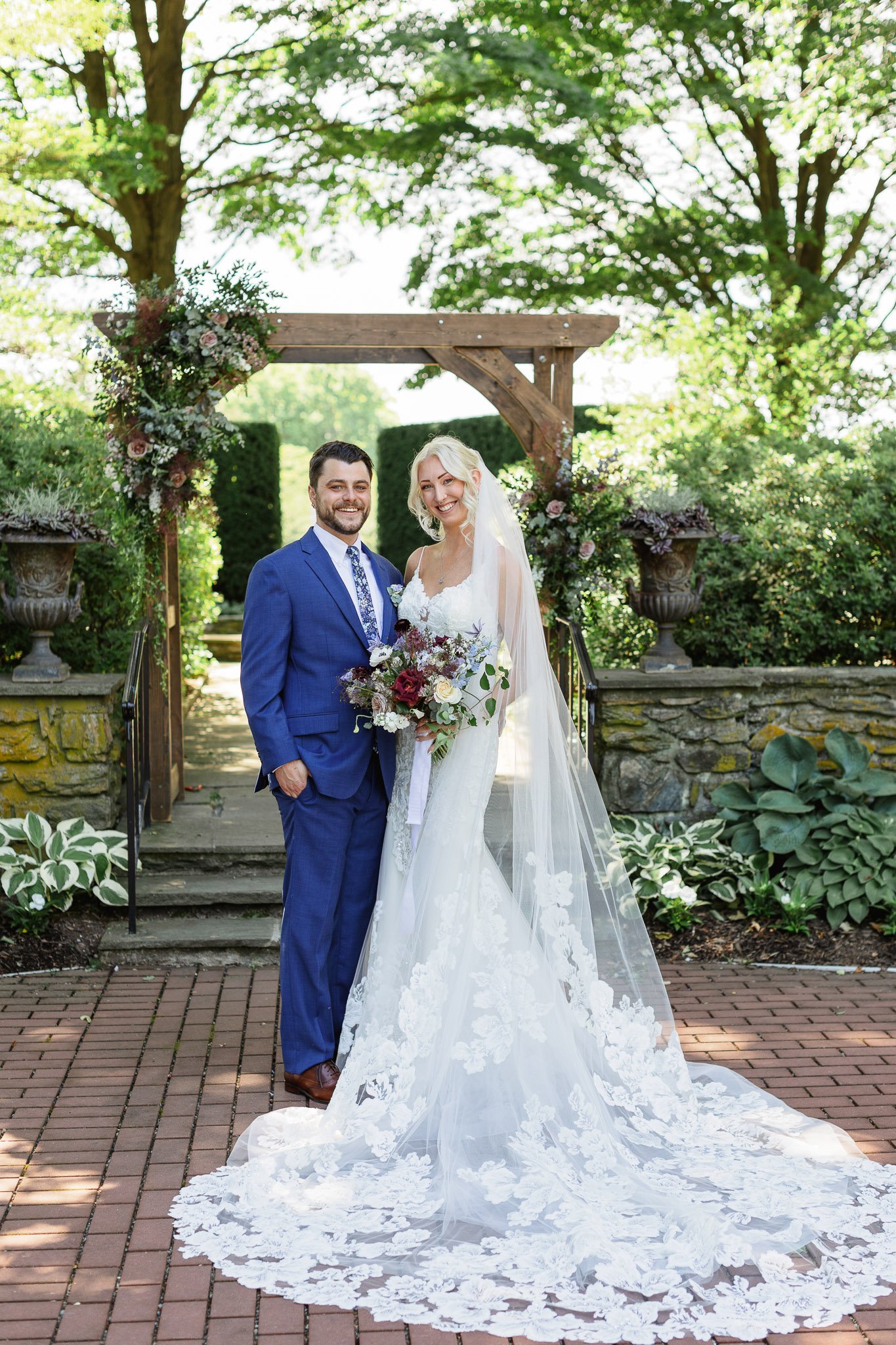 A posed wedding photo of the bride and groom in The Gardens at Drumore Estate