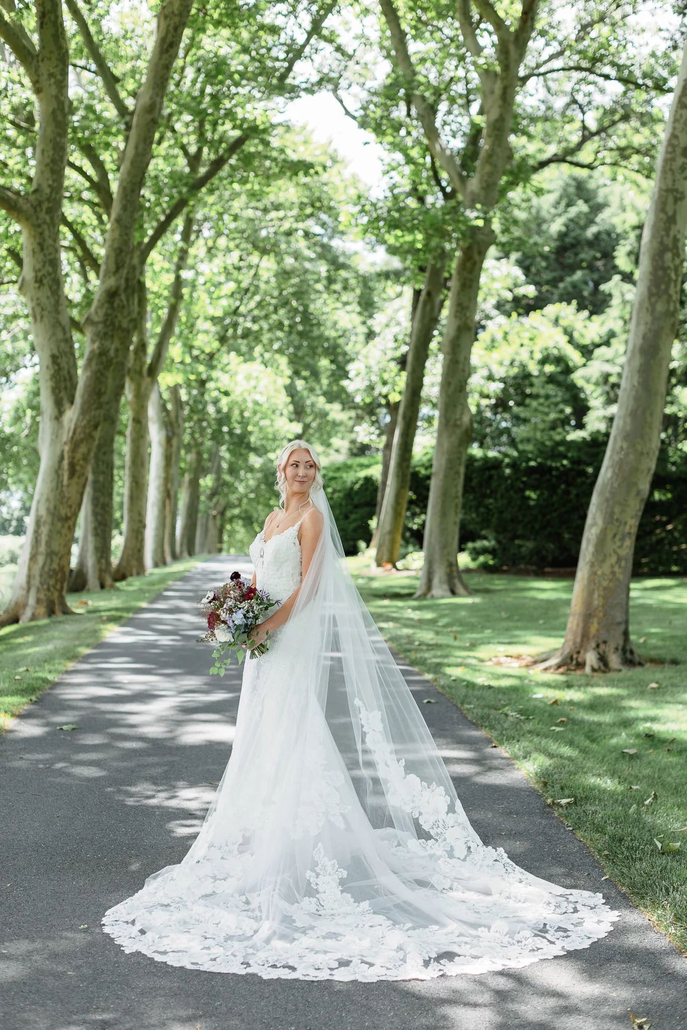 A solo shot of the bride enjoying the lush greenery of the Drumore Estate