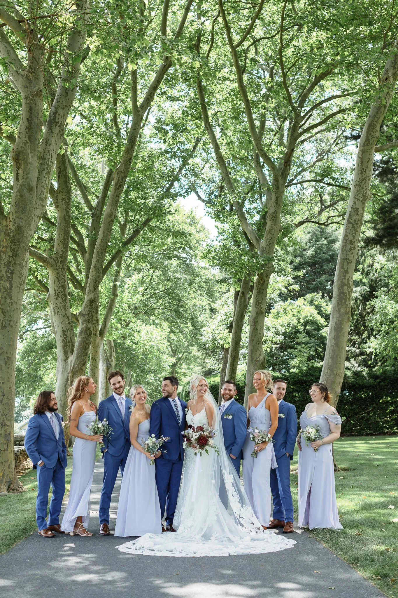A smiling, goofy photo of the wedding party on the Drumore Estate lawn