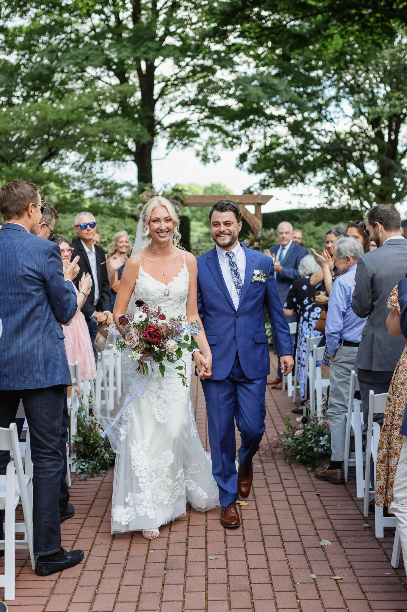 A smiling bride and groom process down the aisle after their Drumore ceremony