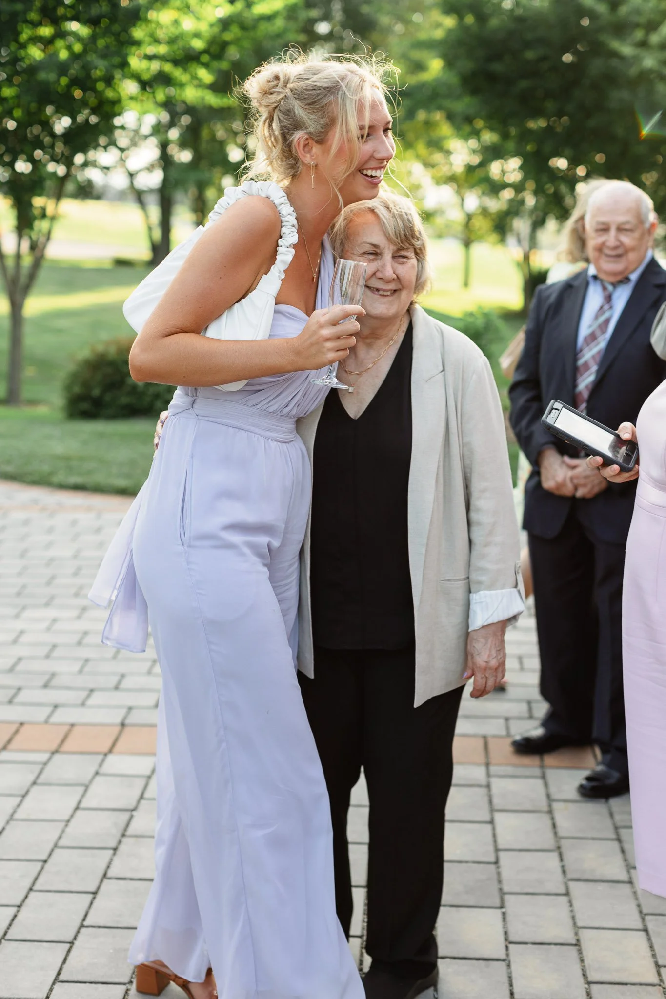 Two wedding guests embrace on the patio at The Drumore Estate