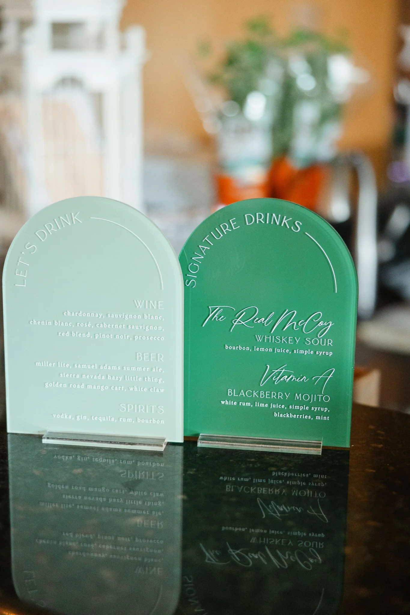 A close-up shot of a custom signature drink menu perched on a bar, detailing the couple's selected cocktails for their Pequea, PA wedding.