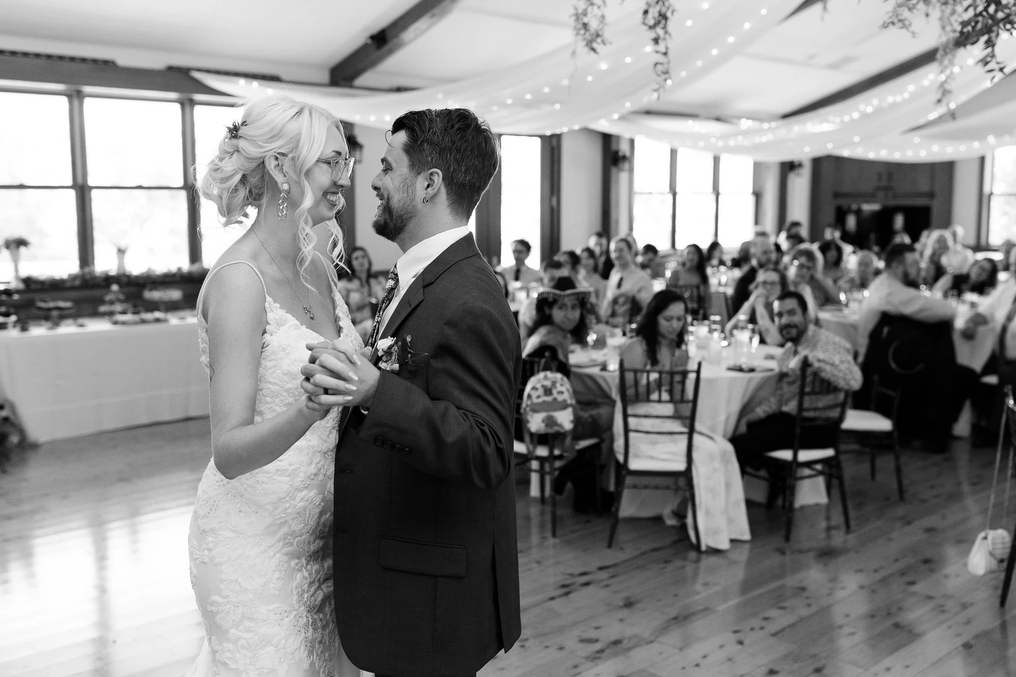A black and white image of the bride and groom enjoying their first dance