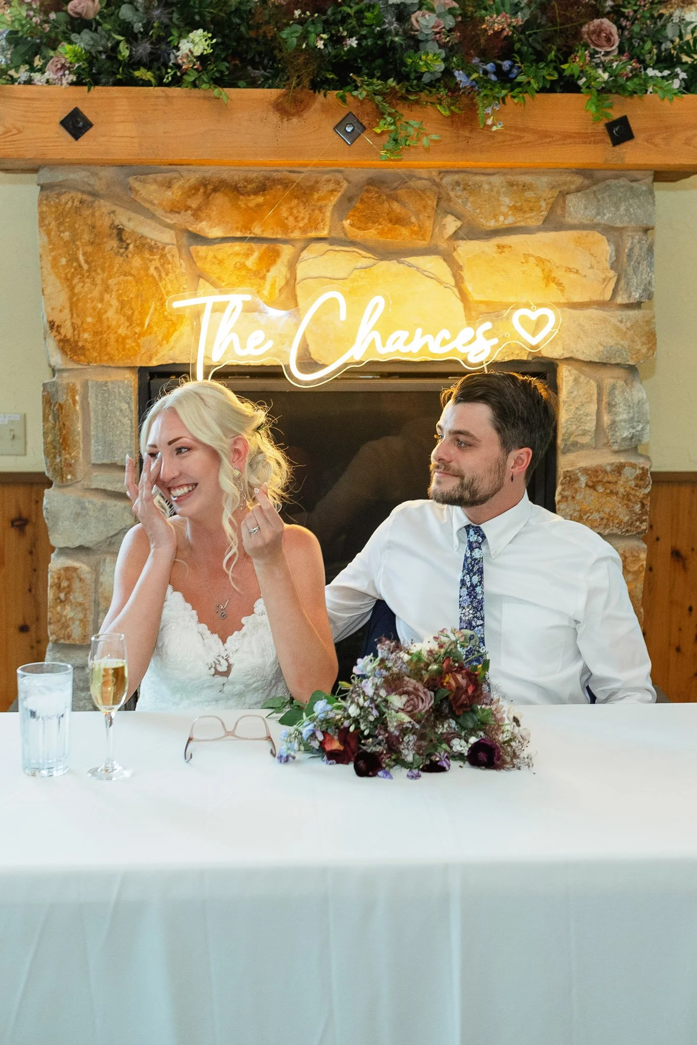 The bride and groom listening to their wedding speeches during the reception