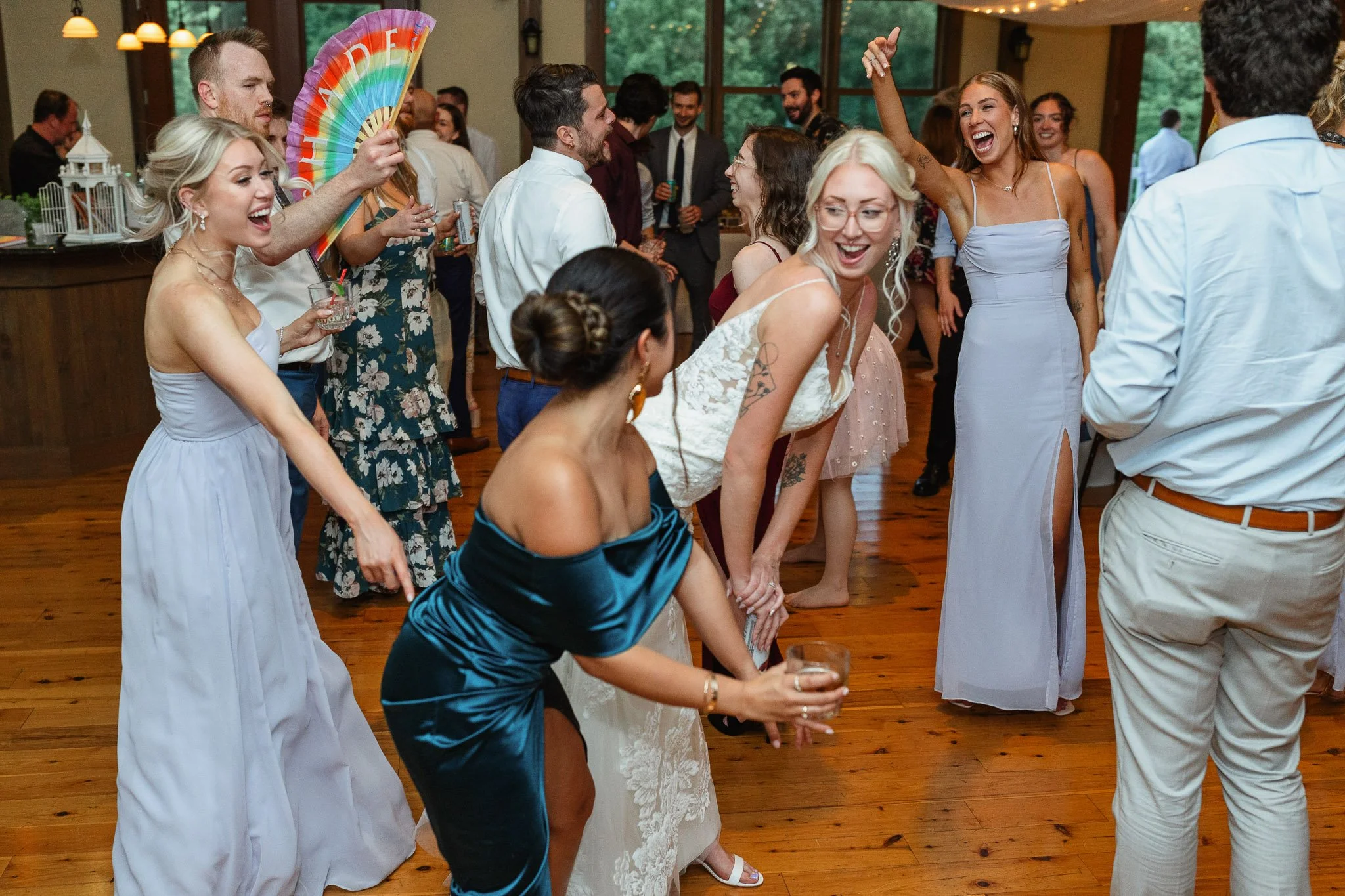 A vibrant wedding photo focusing on the fun atmosphere as guests enjoy the music at the end of the night.