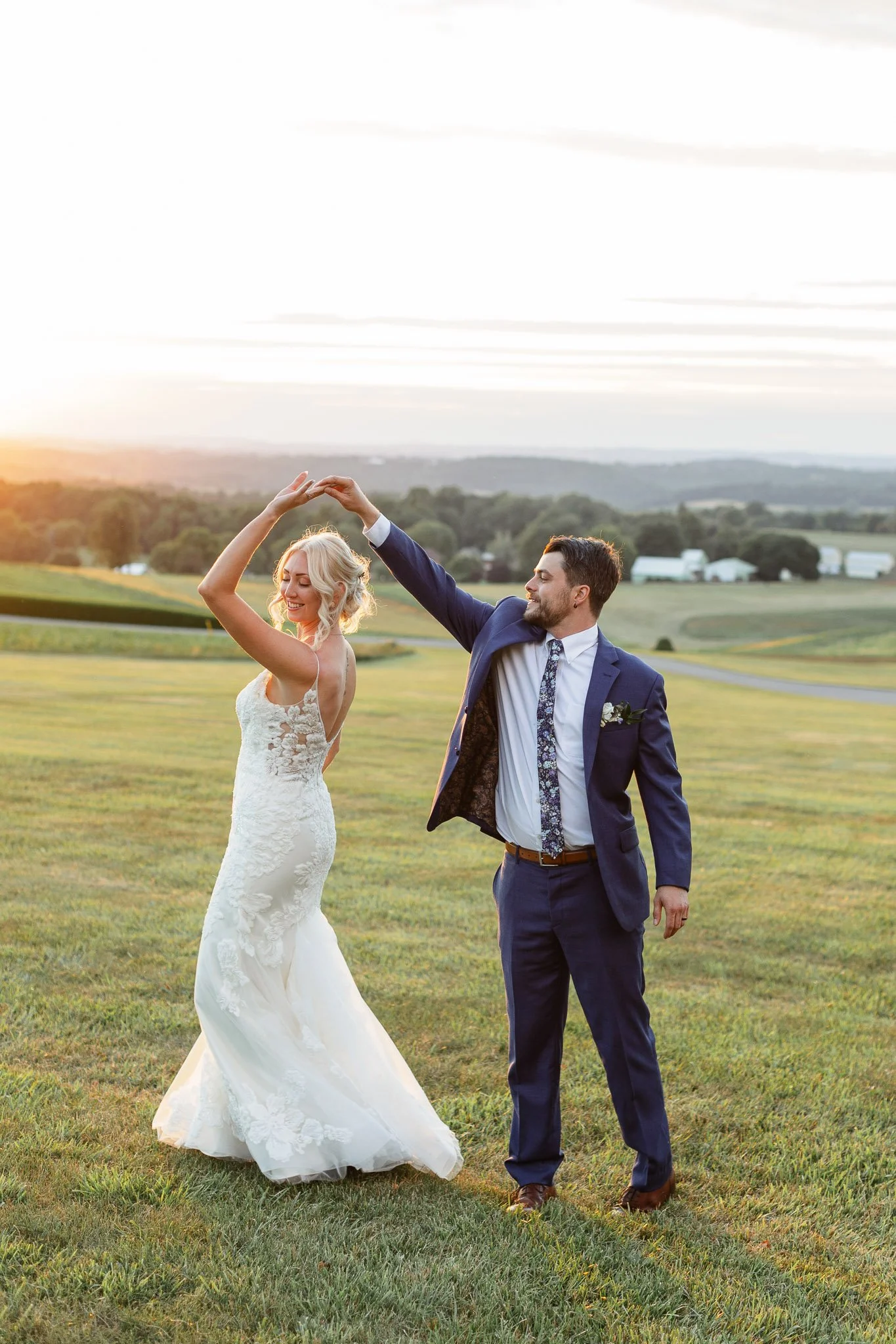 A groom spins his bride during a stunning sunset session at Drumore Estate