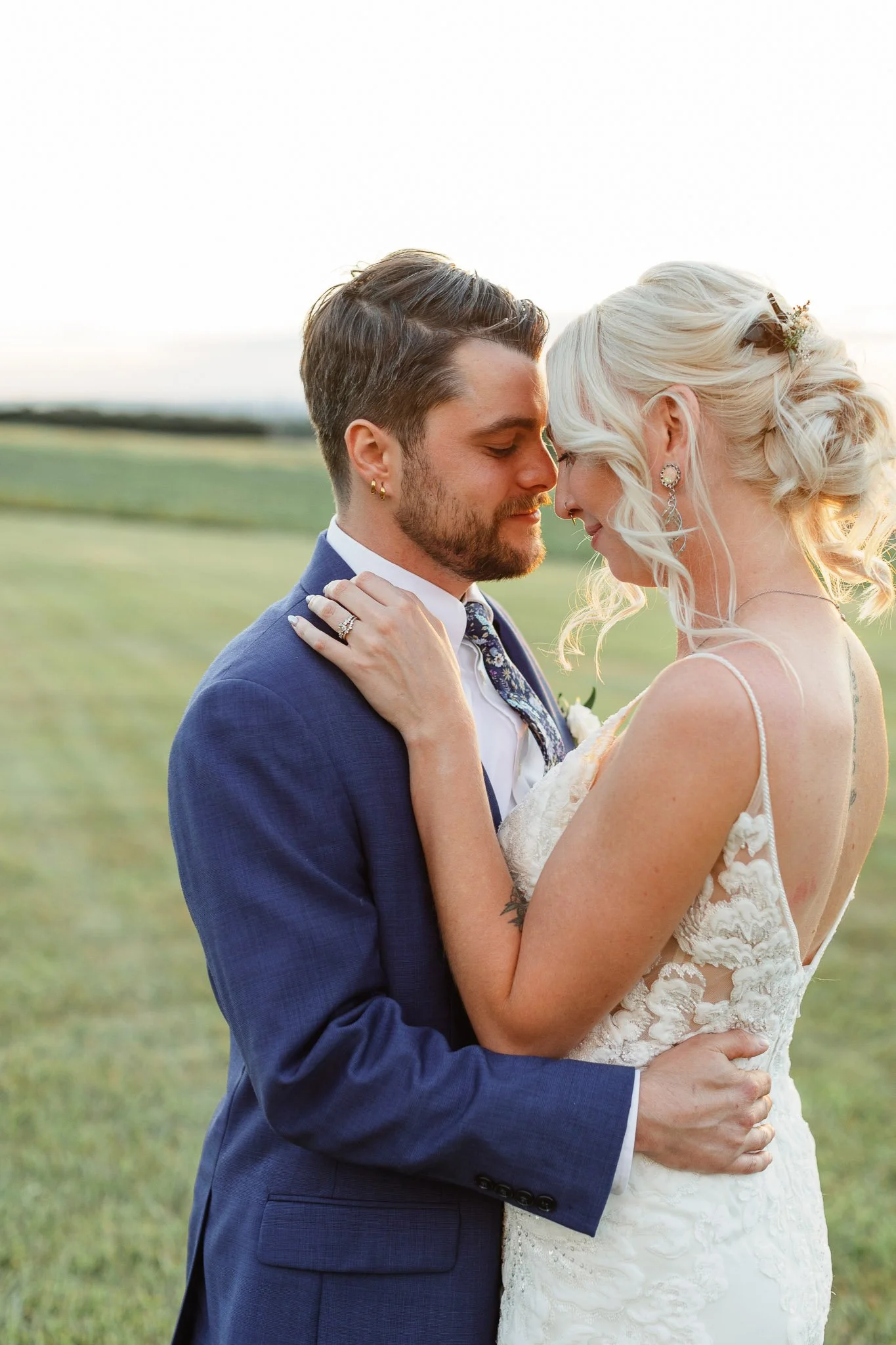 A wedding photographer captures a private moment between bride and groom