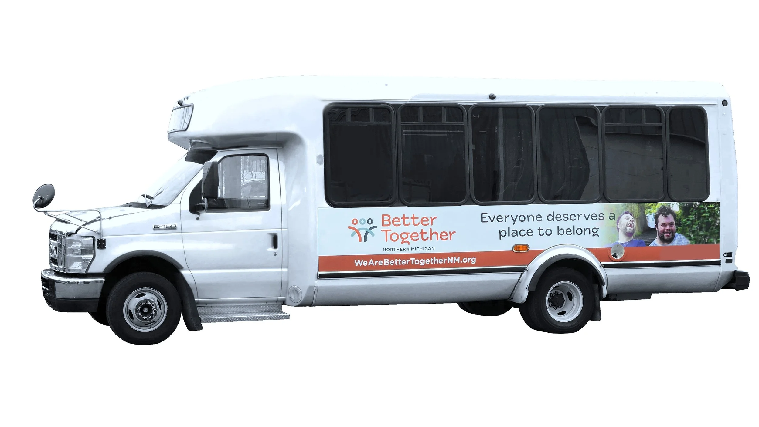 White bus with a graphic and text promoting Better Together, featuring smiling people and a message about belonging, with web address onboard.