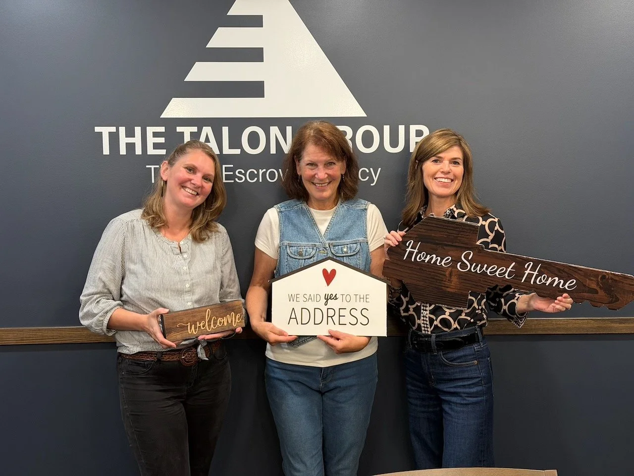 Our founder, executive director, and board president posing after finalizing title paperwork to initiate our contract.