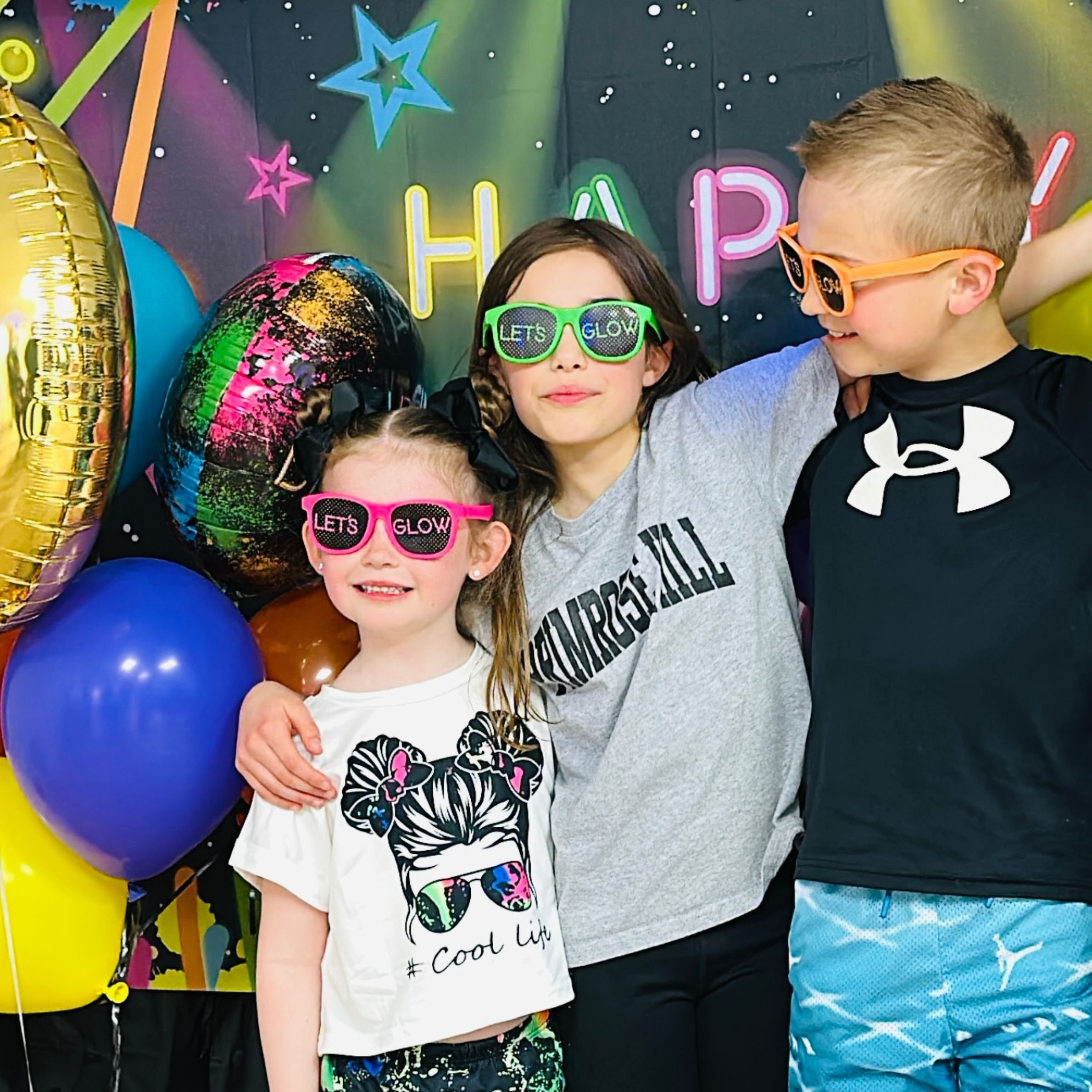 Kids celebrating at a glow art party.