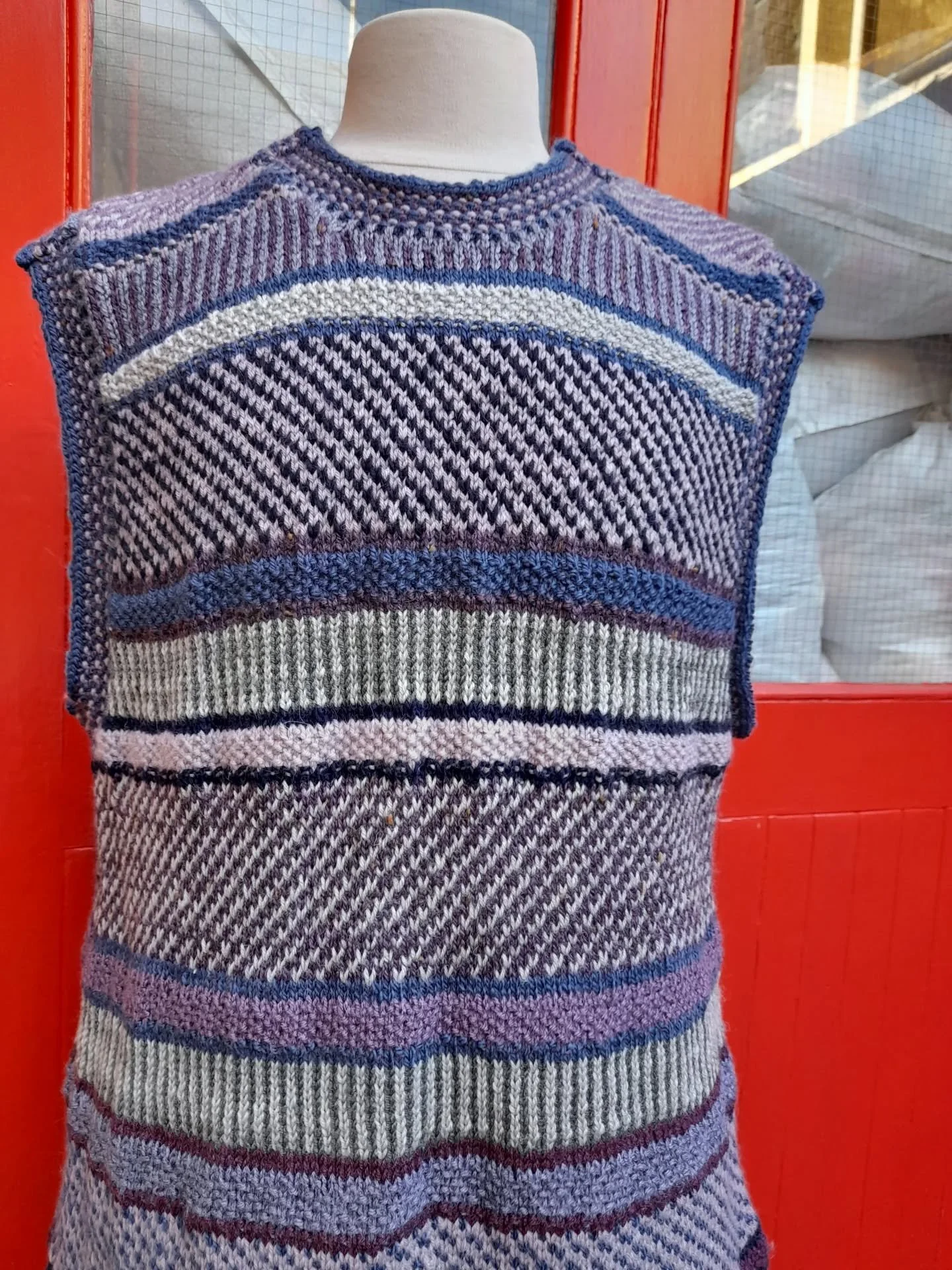 Opinions differed at KFP HQ as to whether this is a Jenkins or a dress which was sent to us anonymously. What is certain is how brilliant it is.  We love the variety of stitches and textures as well as the cool colours used. What a useful and stylish