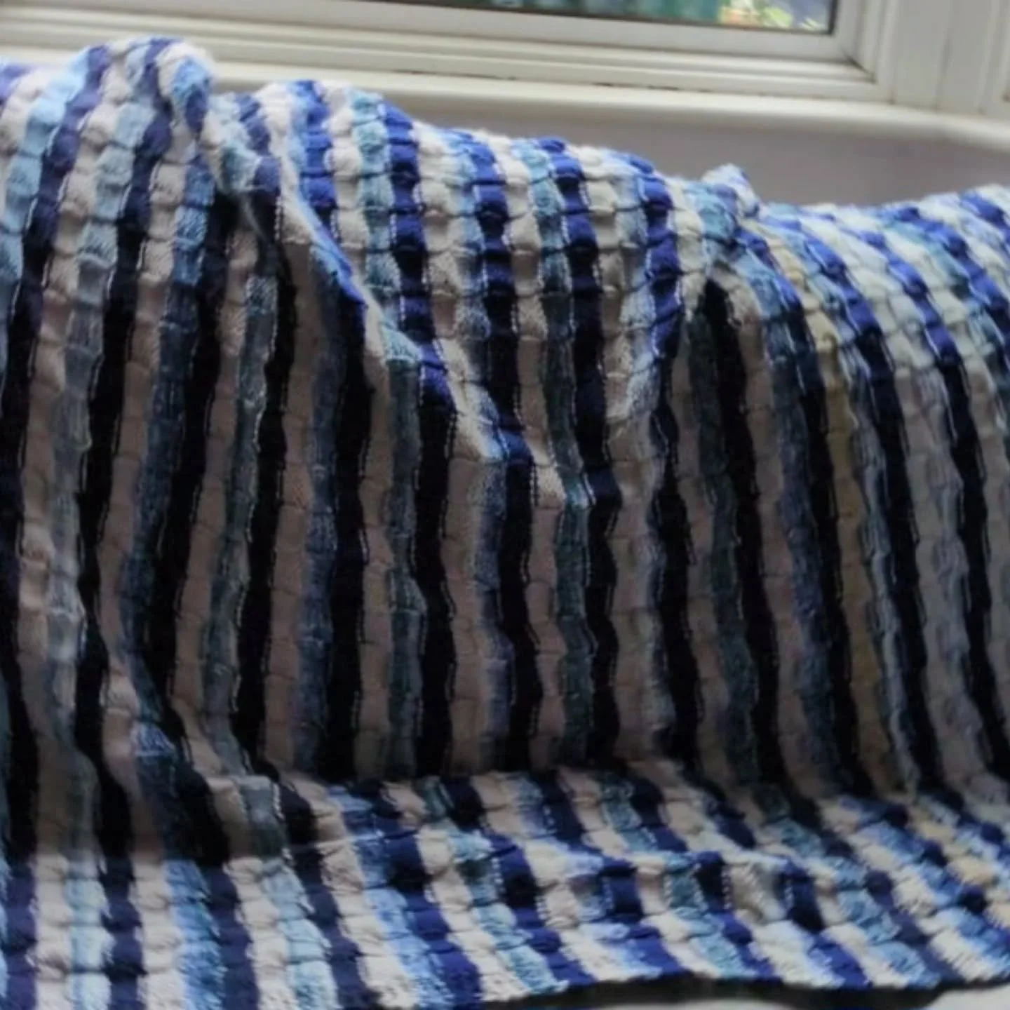 Today's Knit of the Day was made by KFP volunteer Stella. She says she made it from donated yarn, having picked through our bags of yarn without bands to find coordinating colours. It's a great result and must have kept her knees warm while she was m