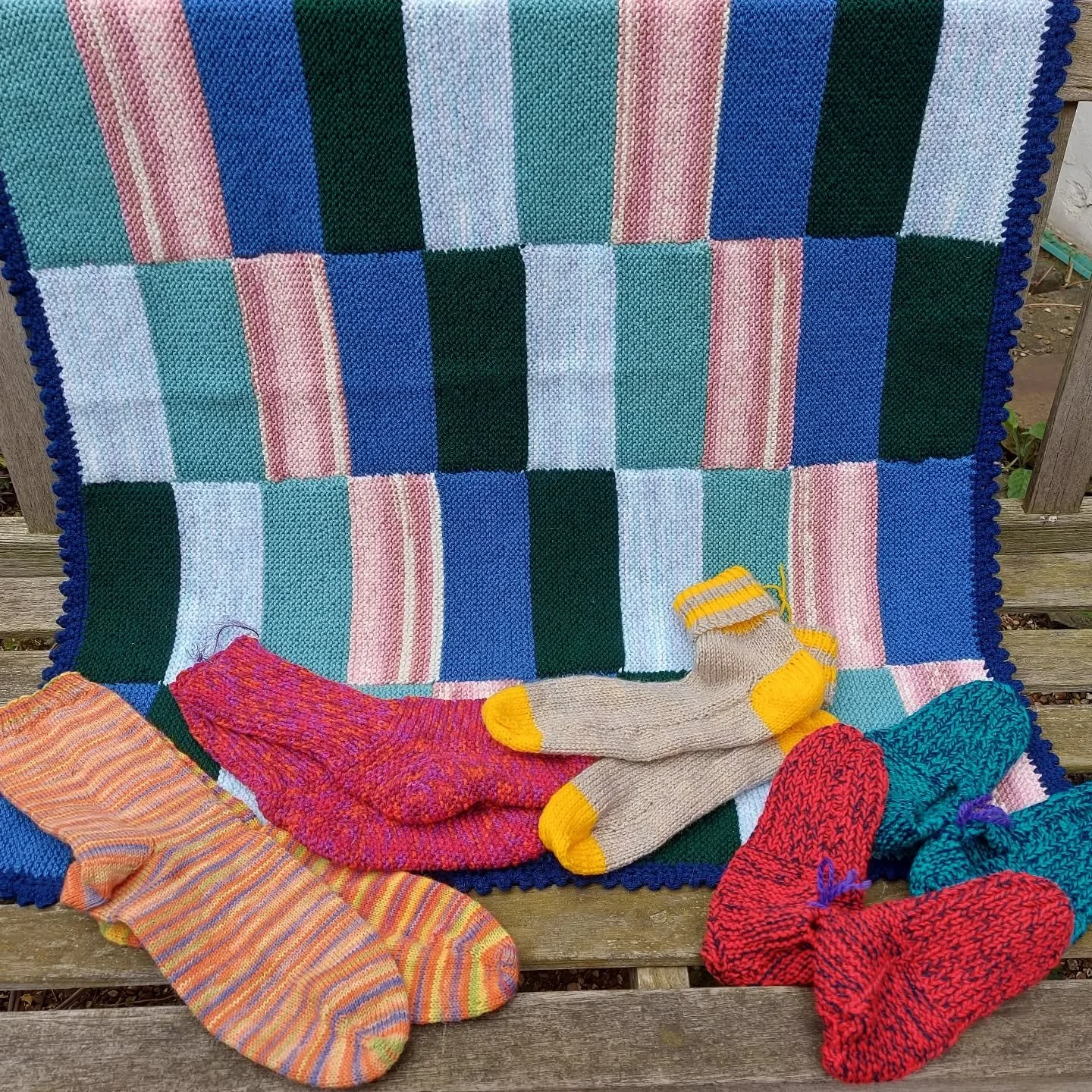 Farnham Assist has sent us a big box of lovely yarny things.  We really like the design of the blanket with its crocheted edging (would you call it a picot border?) and all the cosy socks.

Thank you, Farnham. These are our Knit and Crochet of the Da