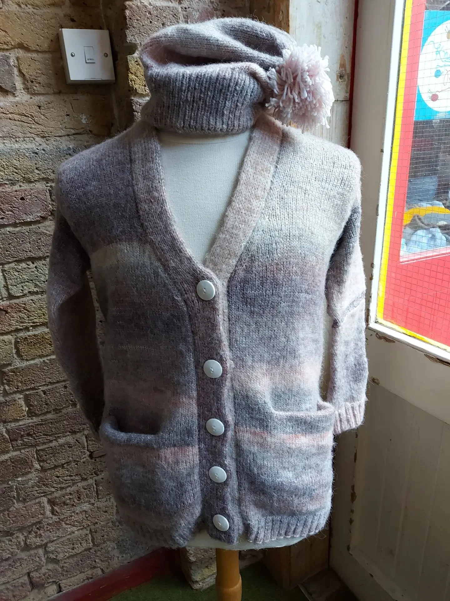 A Nony Mous has been busy again and has sent us this soft and cosy cardigan and bobble hat combo.  It will bring warmth to someone who, I hope, will wear the hat at a jaunty angle!

Thank you, Knitters and Crocheters, for all your donations. 

These 