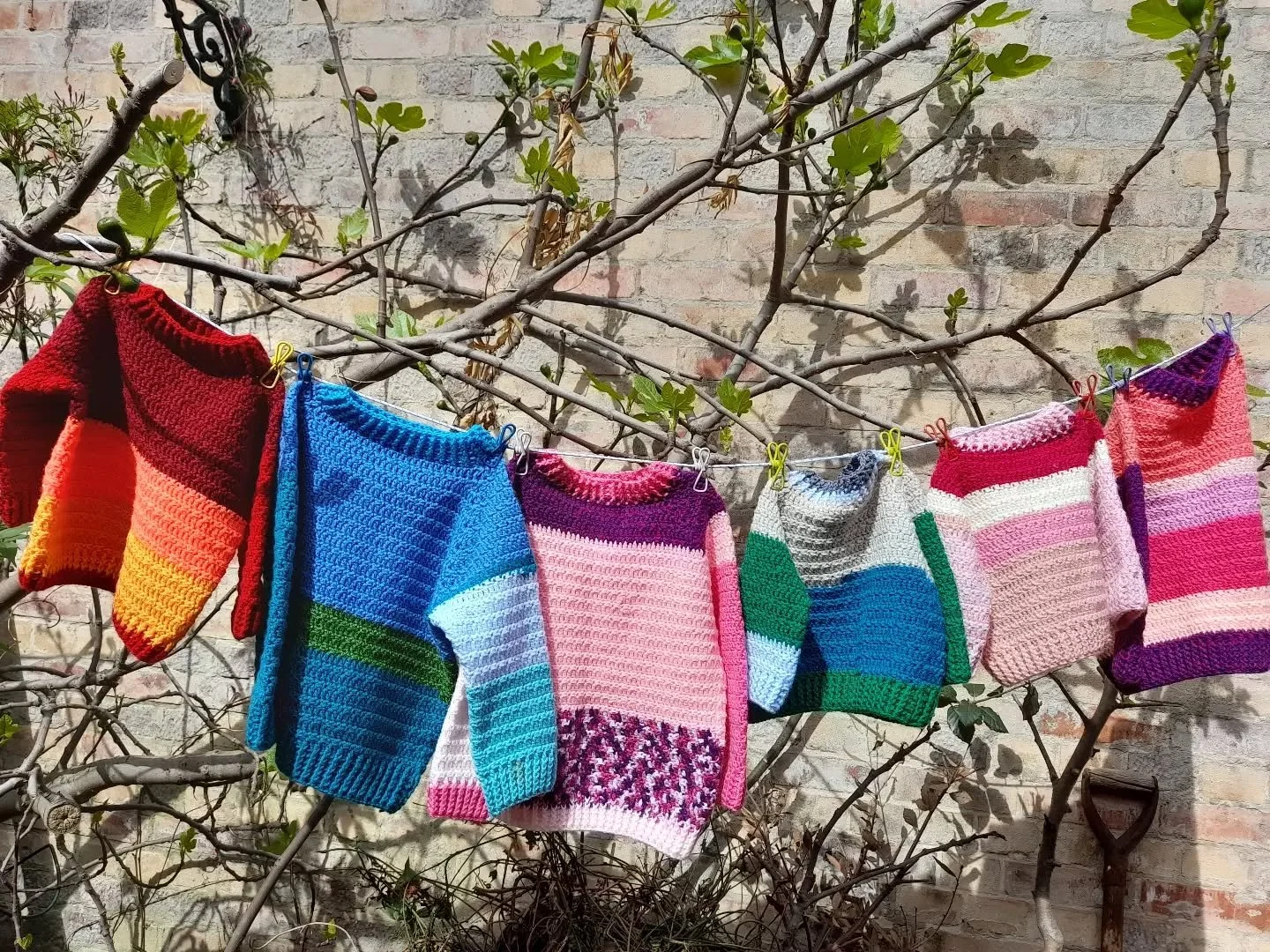 Shirley, on behalf of Moulton Church Knitting Group, has sent us these cute jumpers, which look great in the sunshine.

In her note, Shirley said that she enjoys seeing what other people have made on social media.  That's great to hear. Thank you.  A