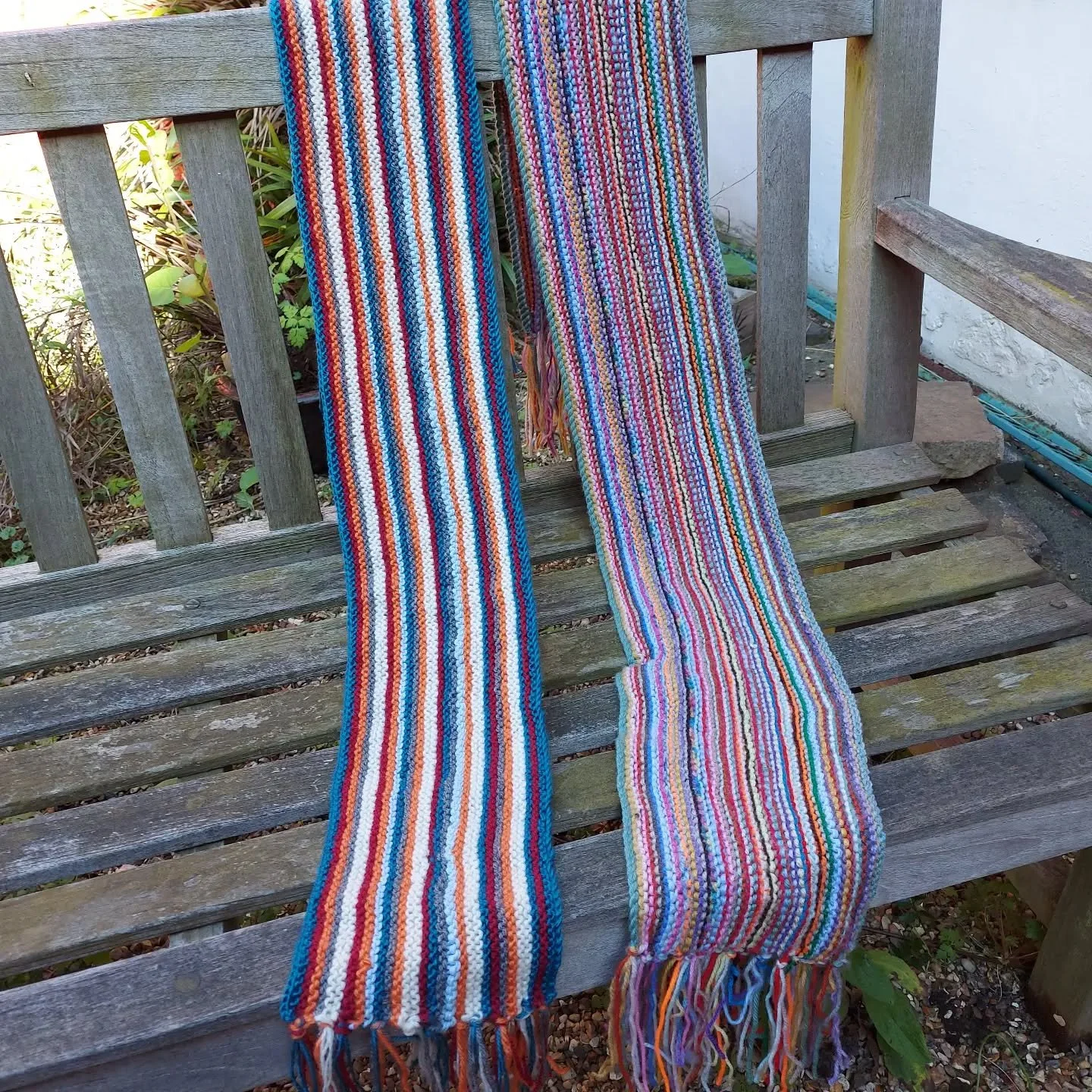 The Crafty Ladies at Cerne Abbas sent us a lovely collection of their creations. We always enjoy seeing this style of long, stripy scarves.  They are an excellent stashbuster project, with an inbuilt fringe.  Perfect!

Thank you, Crafty Ladies. These