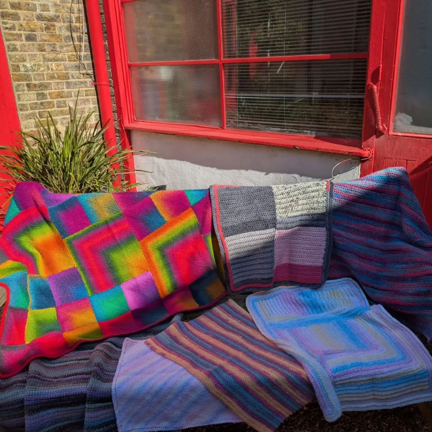 As Spring hints at Summer, the sun moves around our courtyard, challenging the afternoon photographer.  That doesn't stop us appreciating the bold colour choices in this generous collection of blankets sent to us by Emma. She says she follows us on I