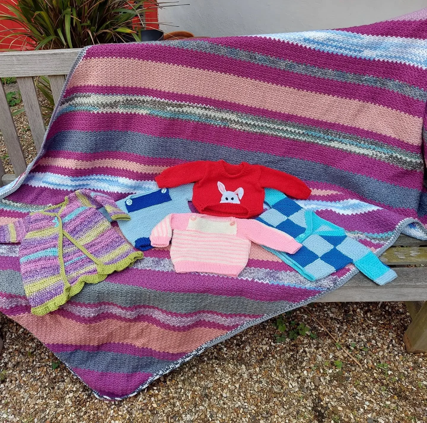Harrow U3A Knitting and Crochet for Fun Group has sent us a wonderful selection of yarny delights.  We love the choice of bright colours and always admire little jackets made with mitred squares.  And who doesn't love a red jumper with a rabbit on it