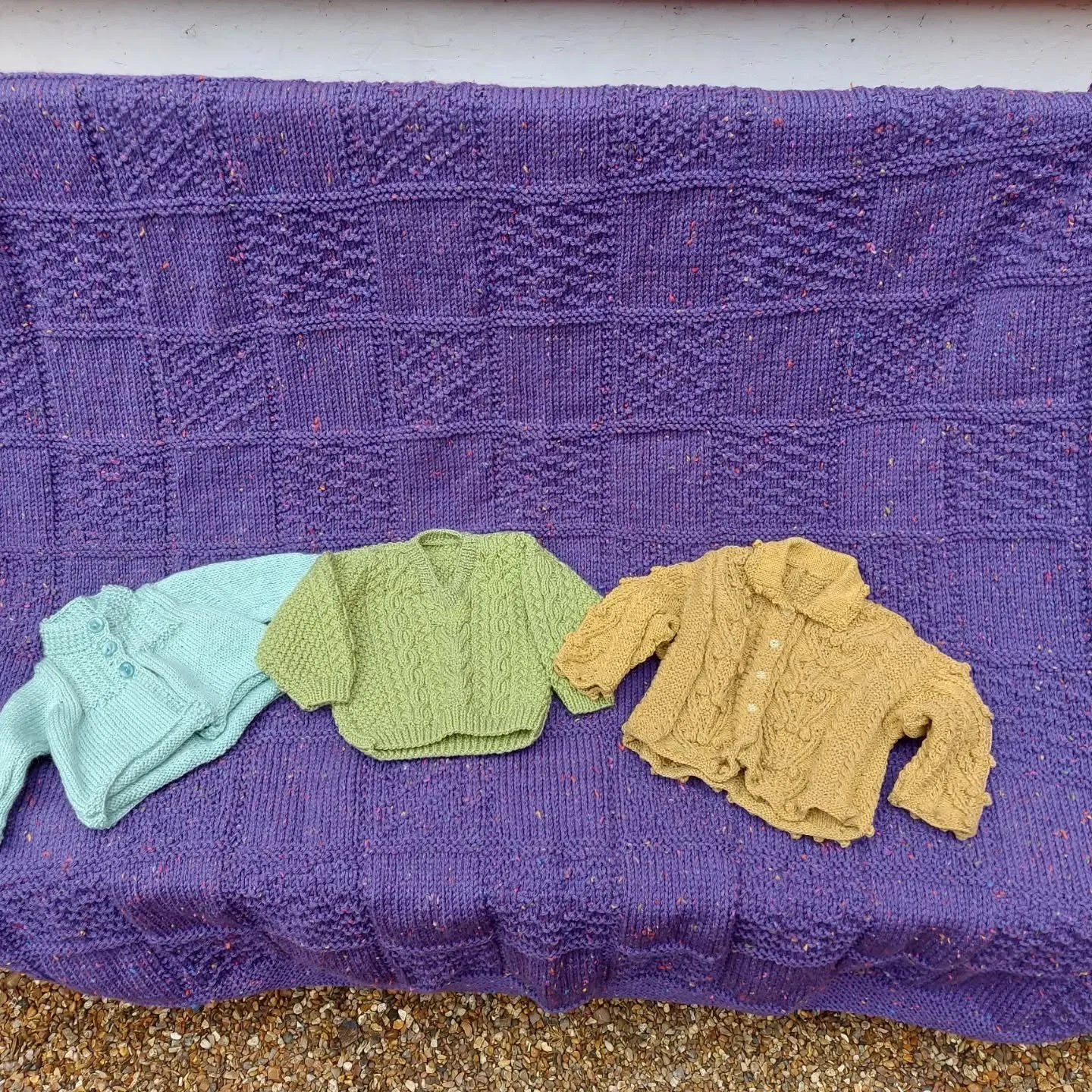 We think Elizabeth in Warrington enjoys textured knitting, and we admire her skill and love the results. This huge blanket is just the thing to wrap yourself in as the weather cools, and the little jackets will add style and interest to any wardrobe.