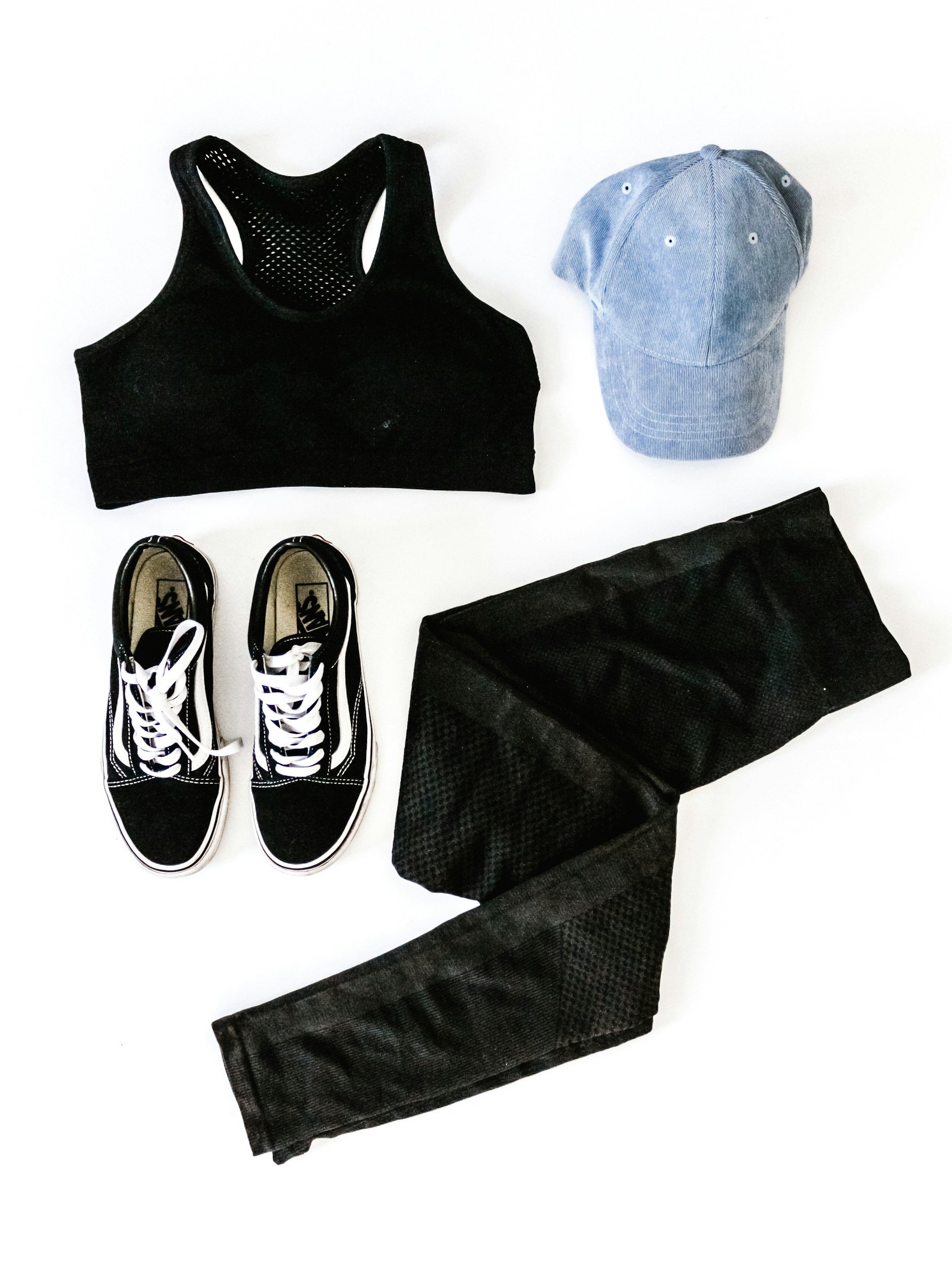 Workout outfit including black sports bra, black and white Vans sneakers, gray baseball cap, and black athletic leggings. This is the requested fit wear of the Forged Jiu Jitsu women's self defense seminar in Ozark, Nixa, and Springfield MO.
