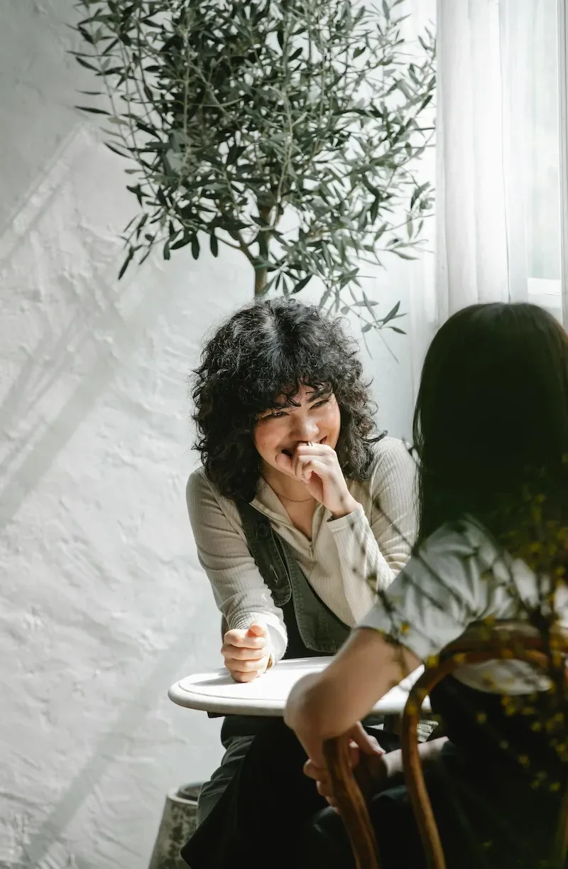 women having coffee together laughing