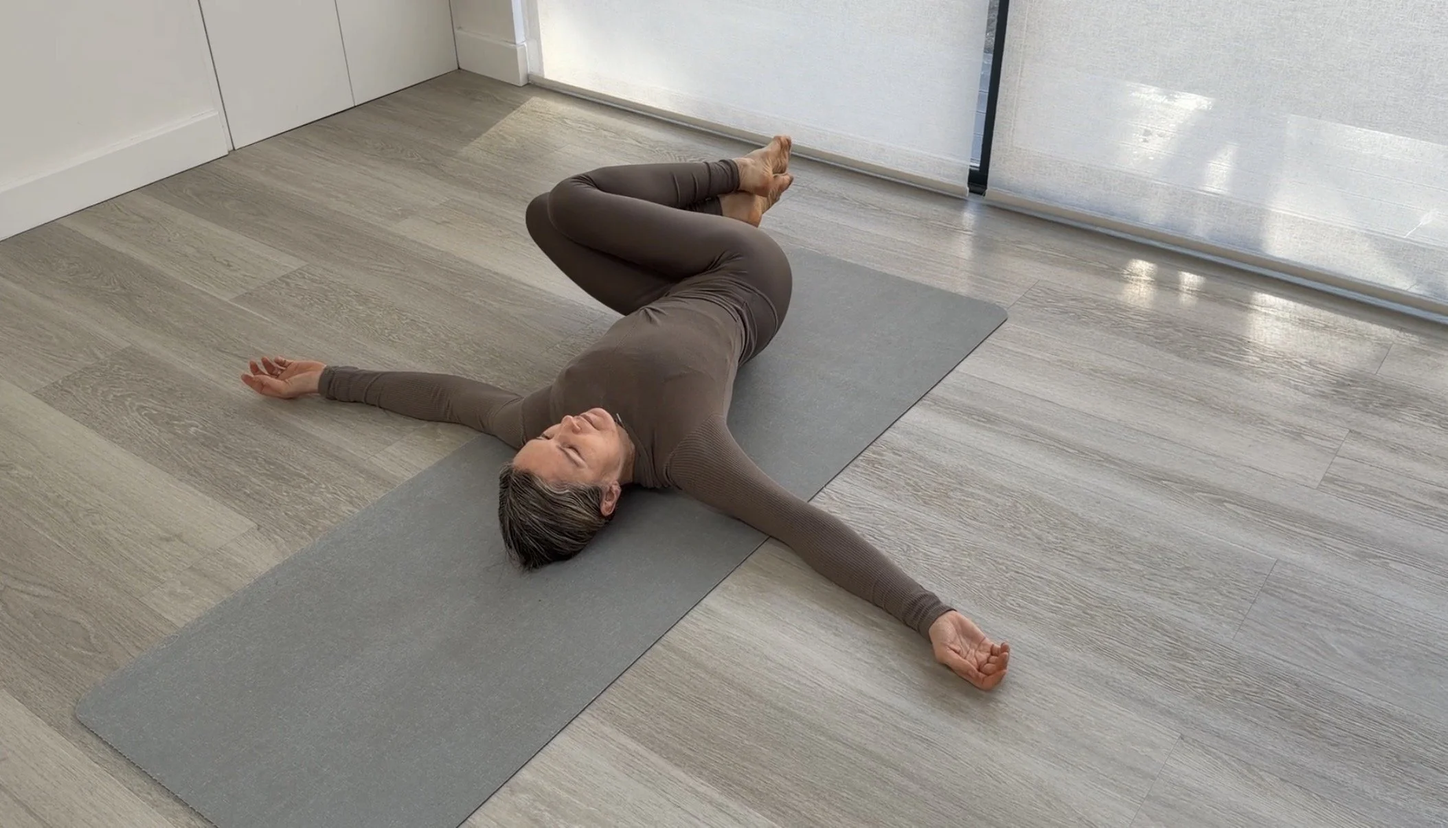 Supine spinal twist yoga pose
