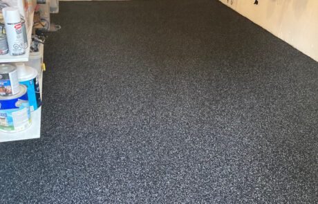 freshly installed Rubberstone floor in a garage with shelves on the side