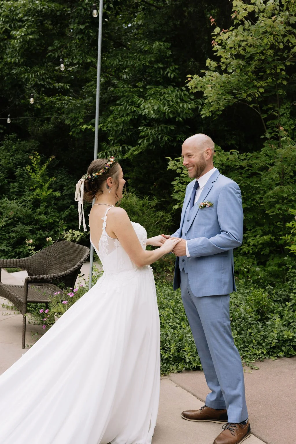 Bride and groom share a joyful first look surrounded by greenery at Carolina Country Weddings — planned by Charlotte Wedding Planner.