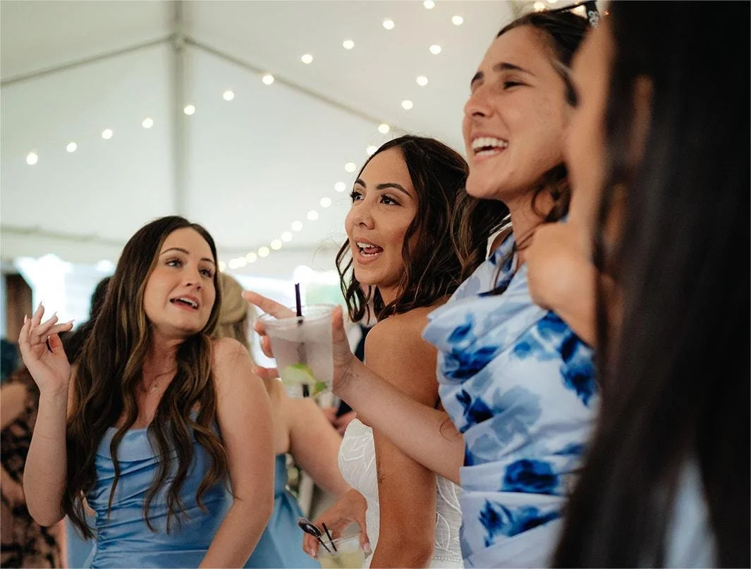 Bride enjoying with bridesmaids on the dance floor.