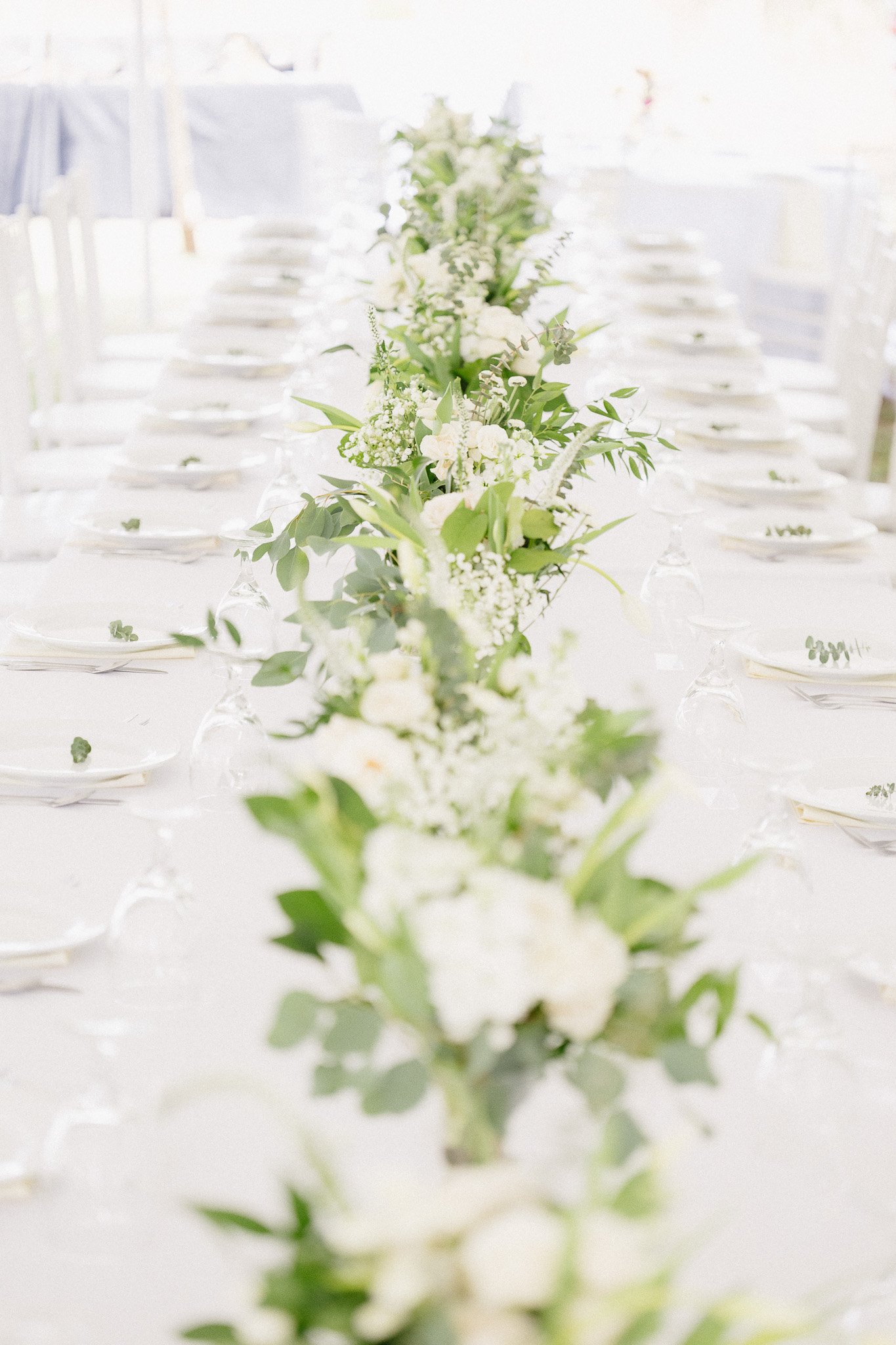 Picture of a head table at a tented wedding planned by a Charlotte wedding planner
