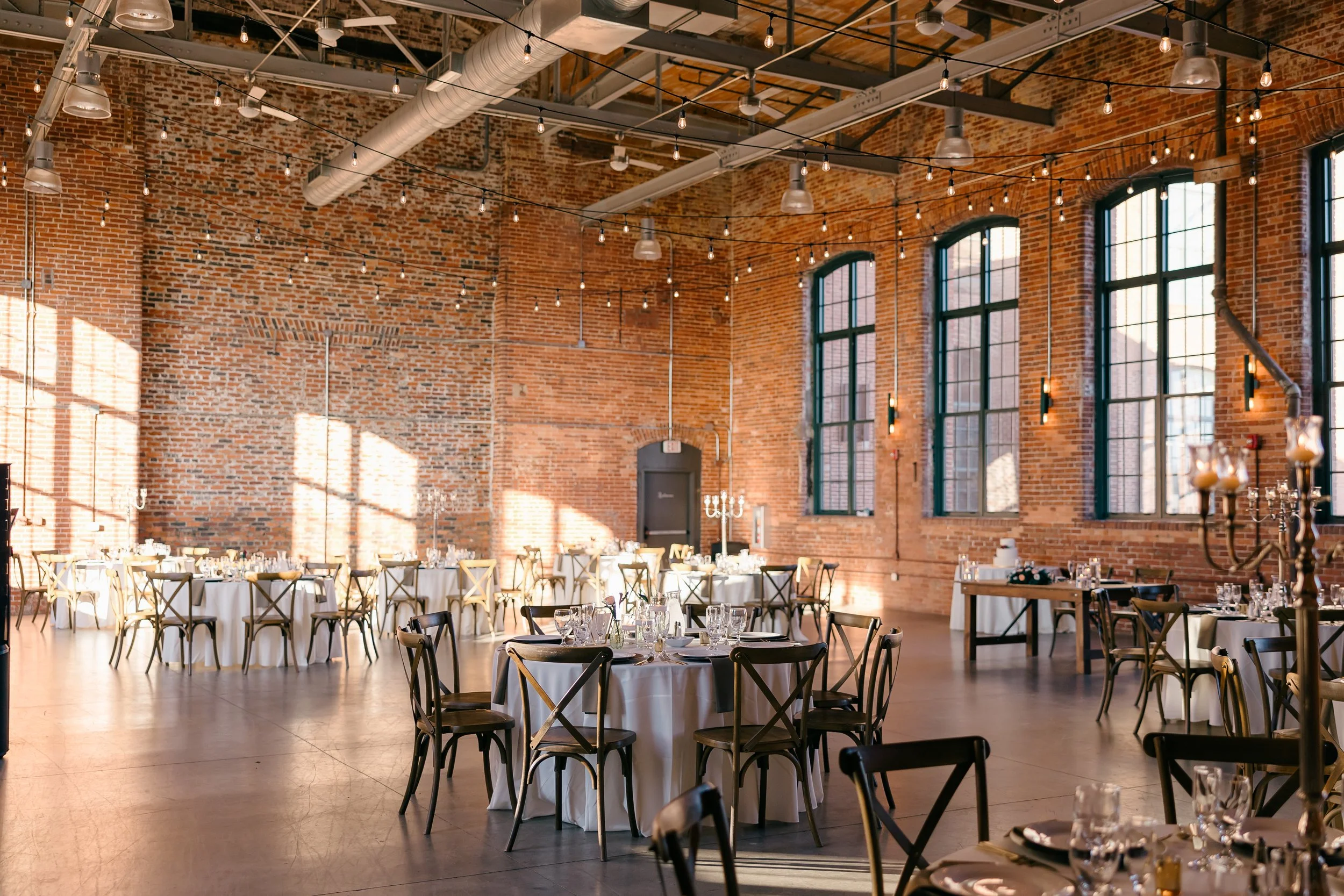 Wedding reception room in a mill venue at a wedding coordinated by a Charlotte wedding planner