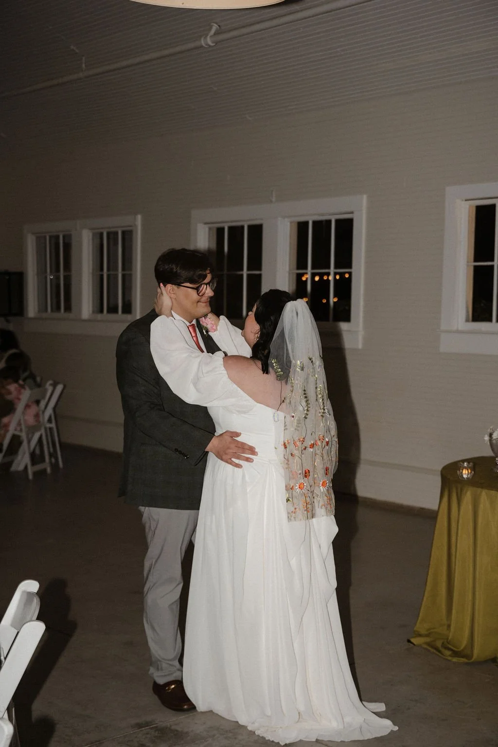 Bride and groom share their first dance surrounded by loved ones, with soft lighting and elegant décor creating a romantic atmosphere — coordinated by Charlotte Wedding Coordinator at Anne Springs Close Greenway.