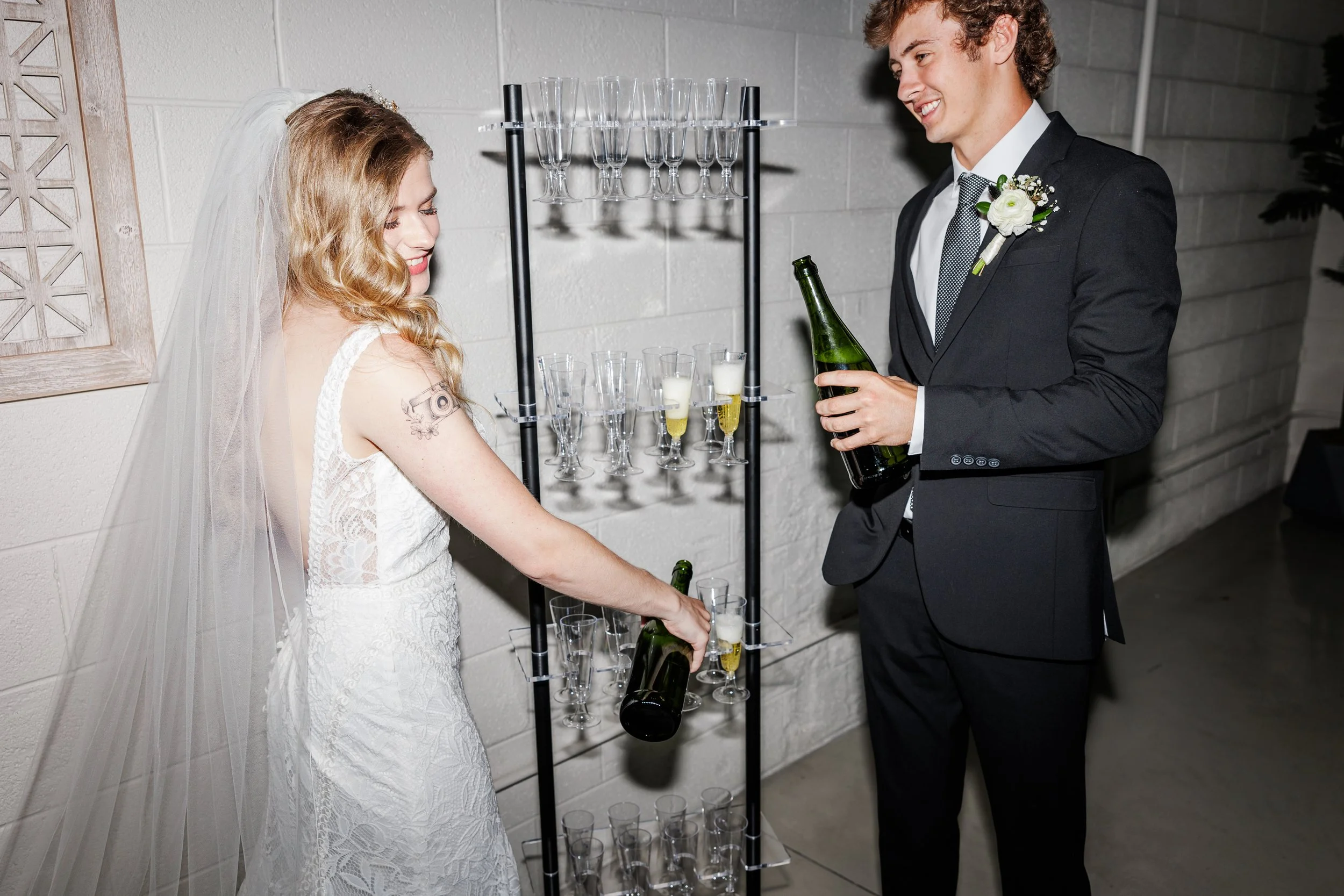 Bride and groom pouring champagne at wedding planned by Charlotte wedding planner