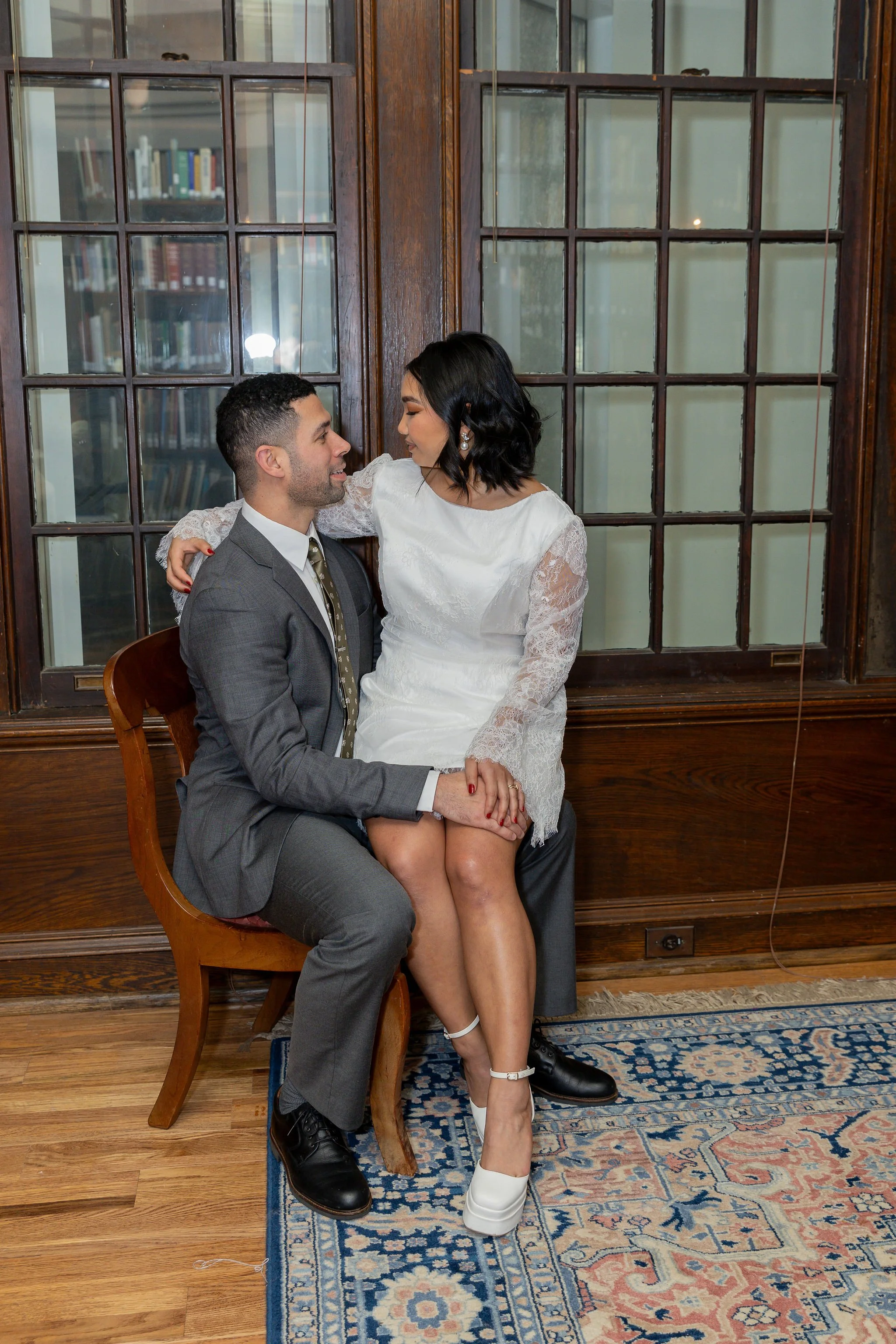 Bride and groom in a library, wedding designed by a Charlotte wedding planner.