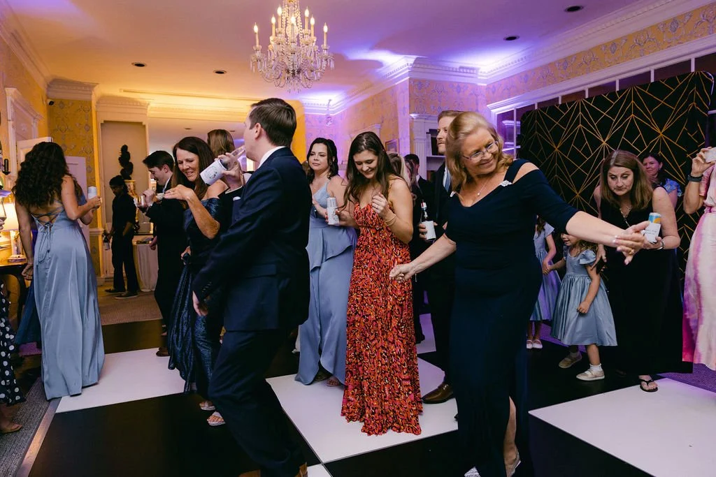 Guests dancing on the dance floor at the wedding reception.