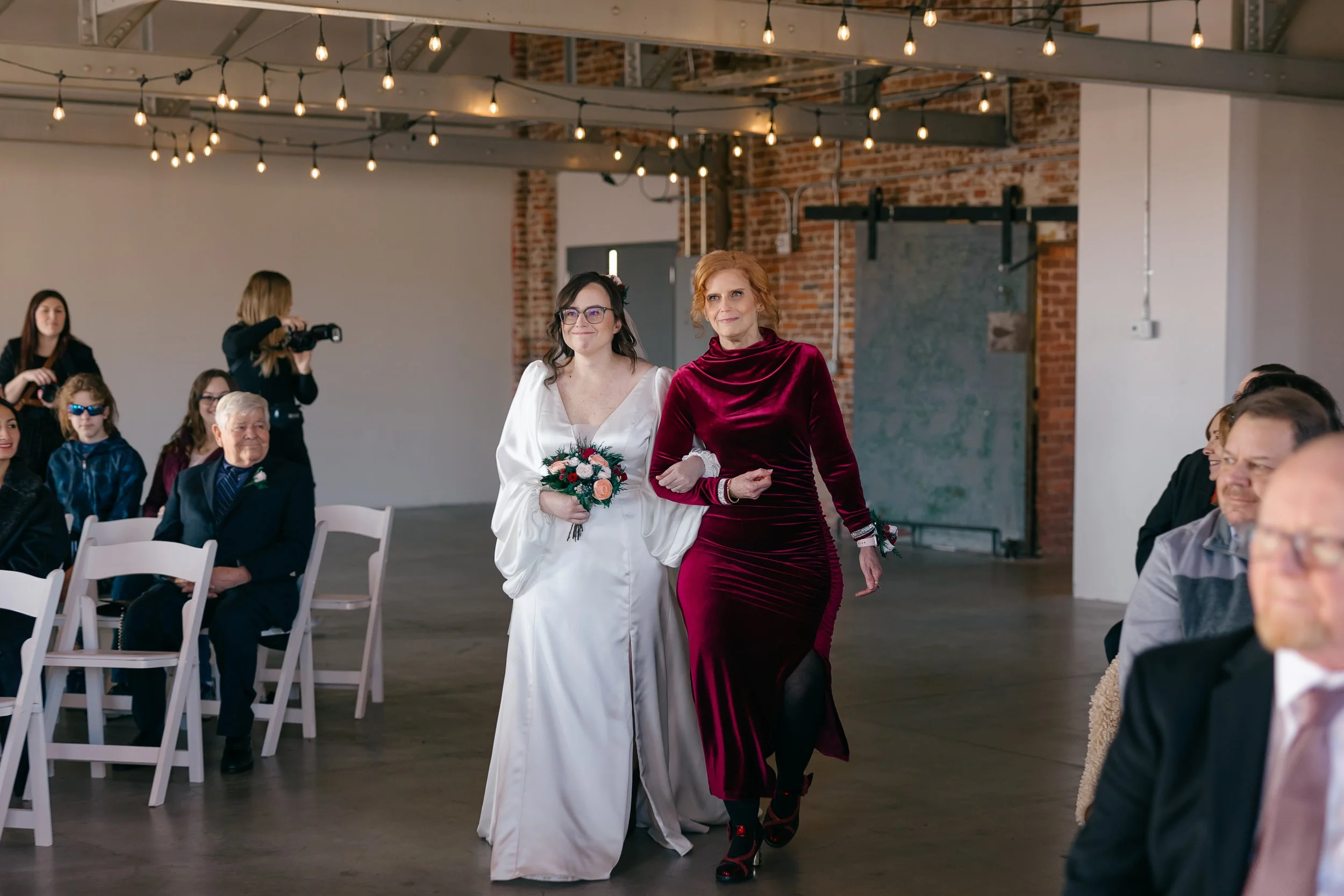 Bride and mom in a mill venue at a wedding coordinated by a Charlotte wedding planner